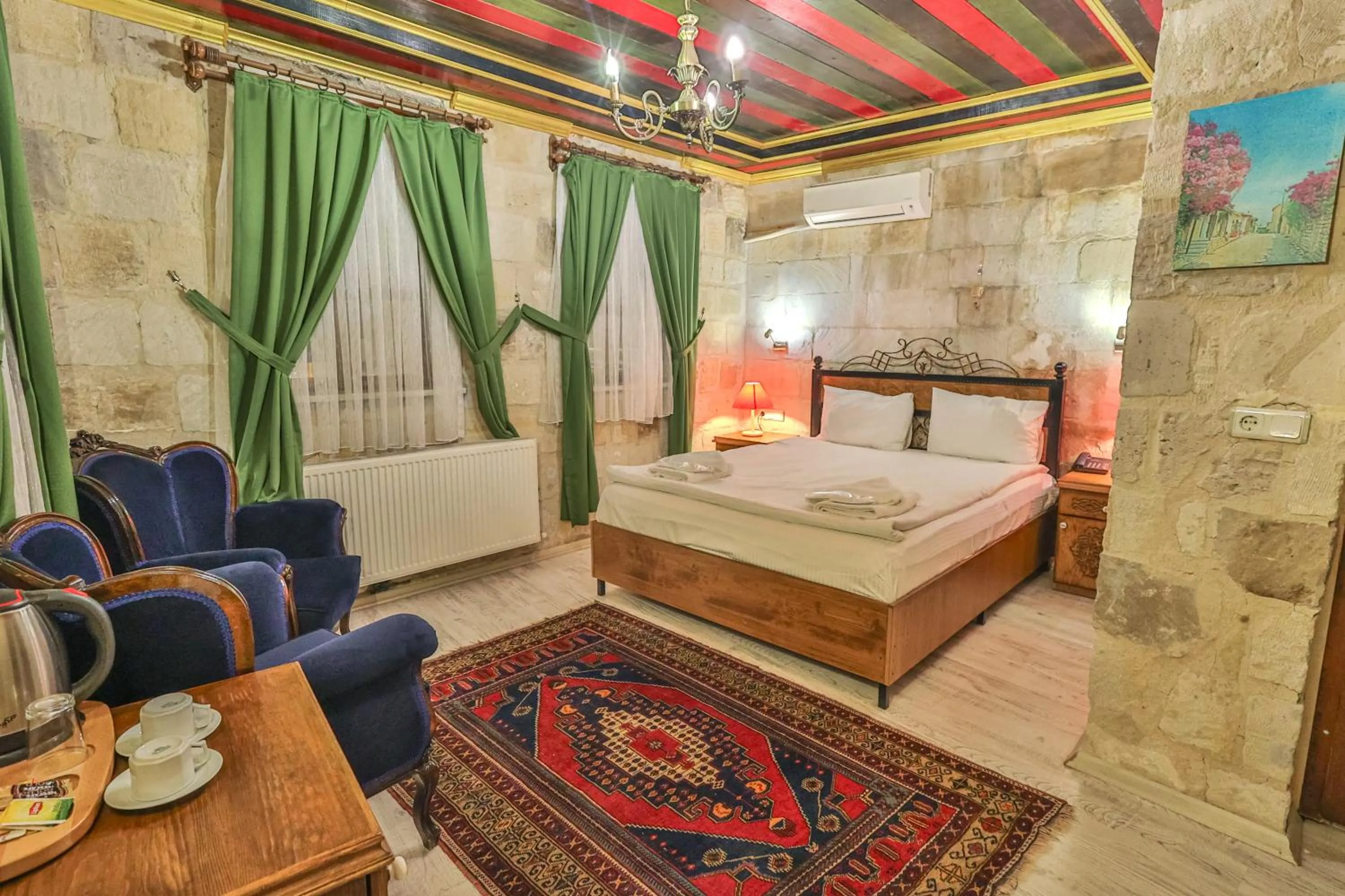 Living room, Bed in Bedrock Cave Hotel