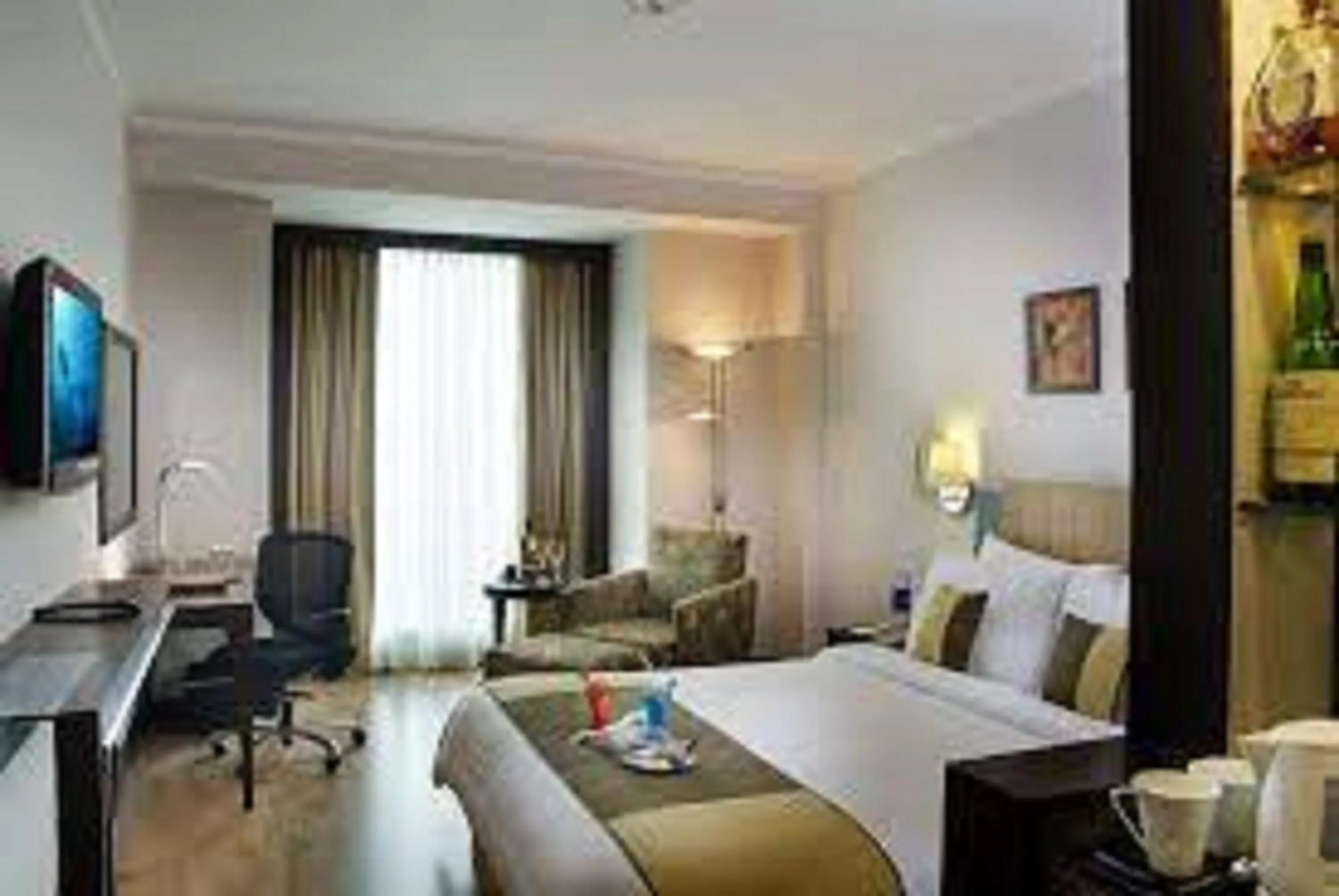 Photo of the whole room, Bed in Goldfinch Hotel Delhi NCR