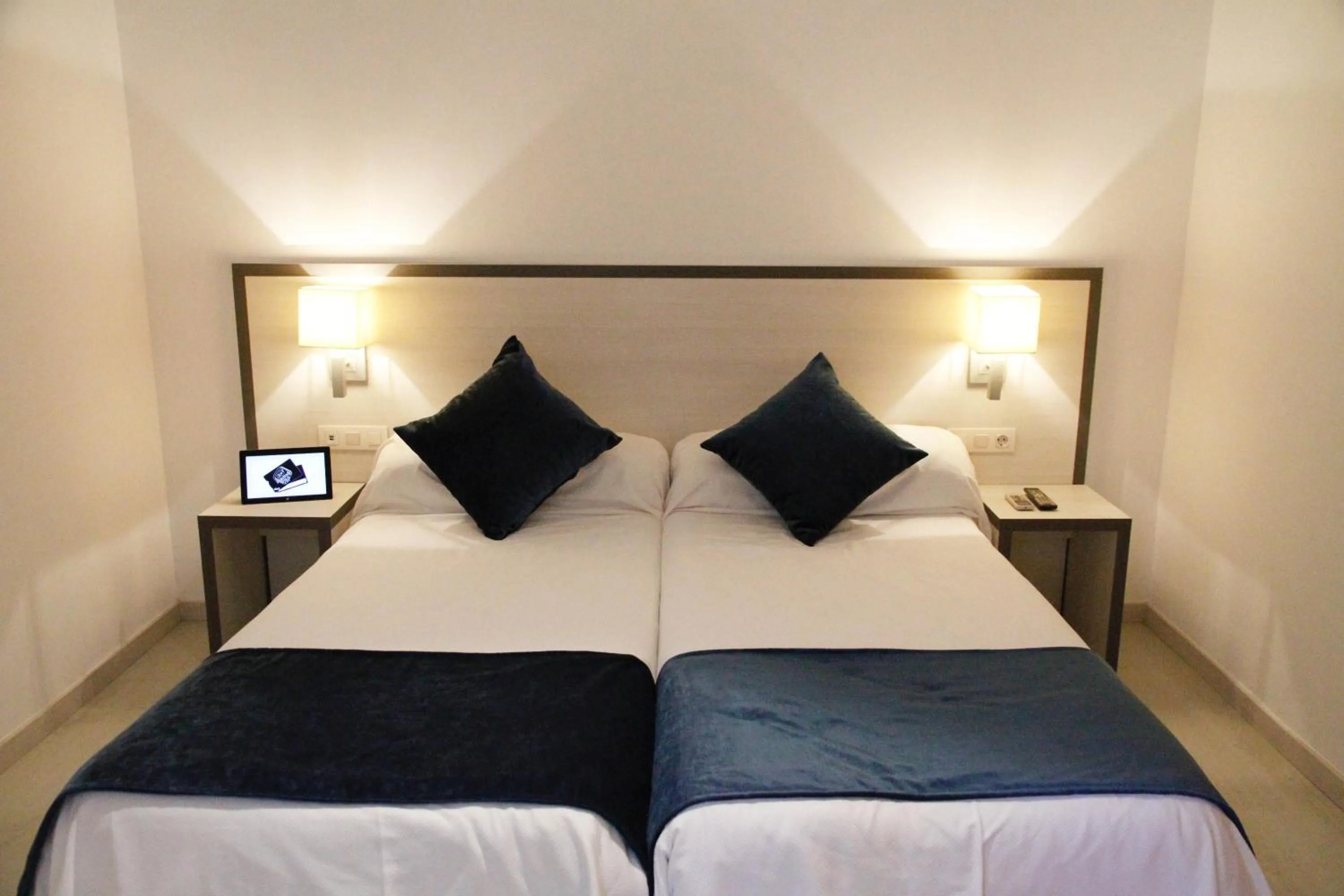 Bed in Parrots Sitges Hotel