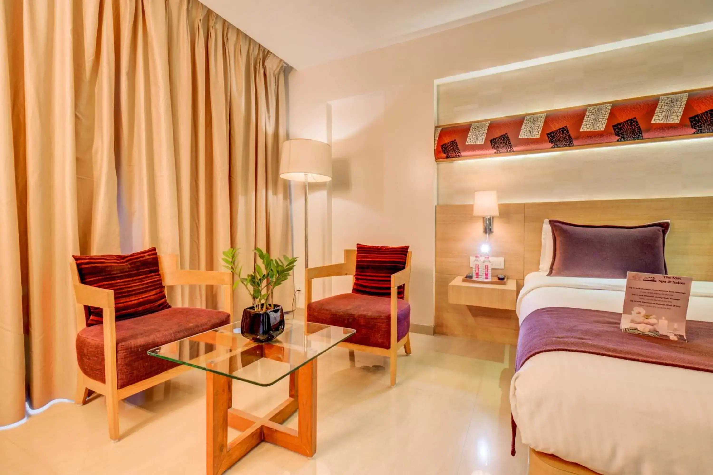 Seating area, Bed in The SSK Solitaire Hotel & Banquets Seating area, Bed in The SSK Solitaire Hotel & Banquets