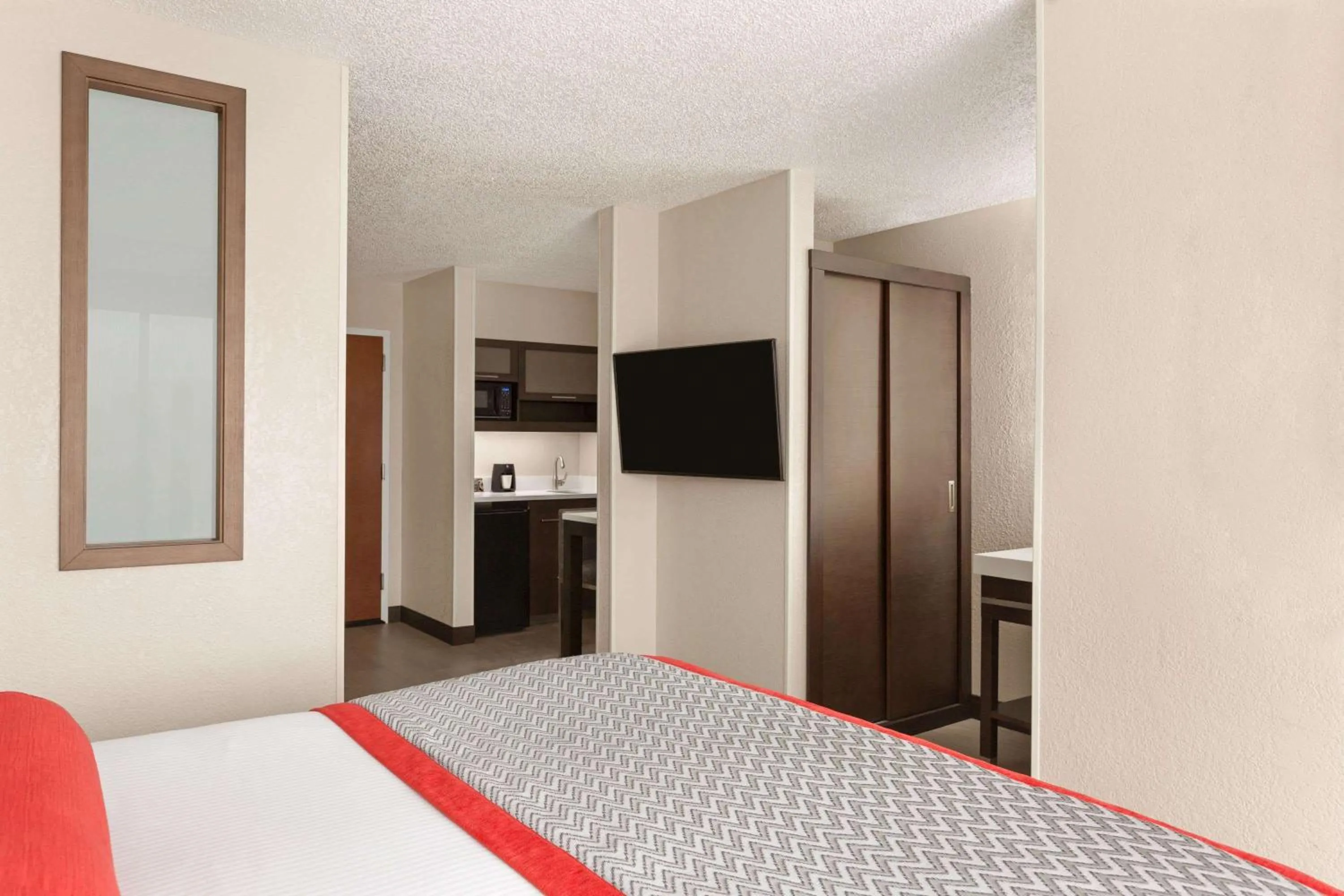 Photo of the whole room, Bed in Ramada by Wyndham Suites Orlando Airport- Free Airport Shuttle