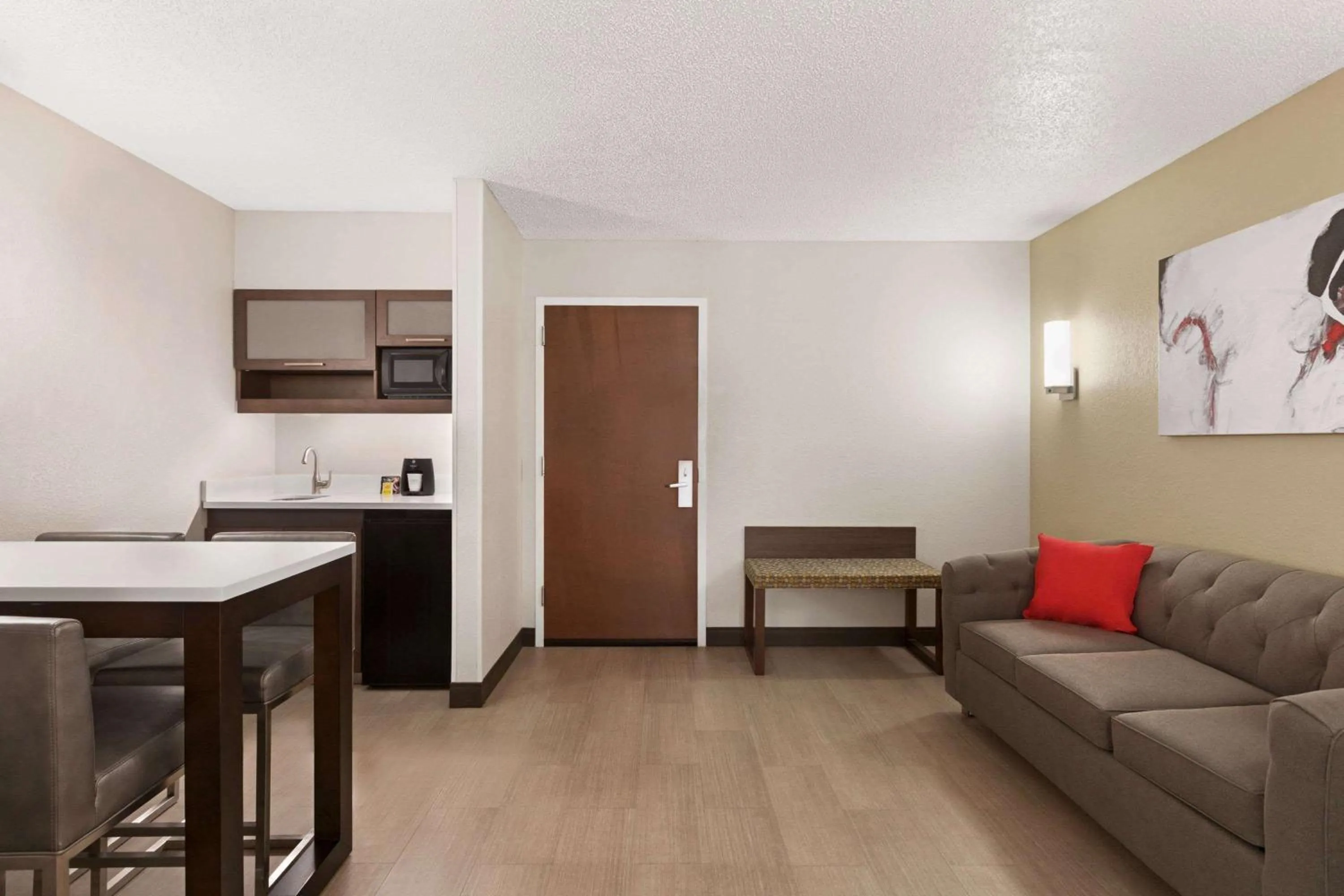 Photo of the whole room in Ramada by Wyndham Suites Orlando Airport- Free Airport Shuttle