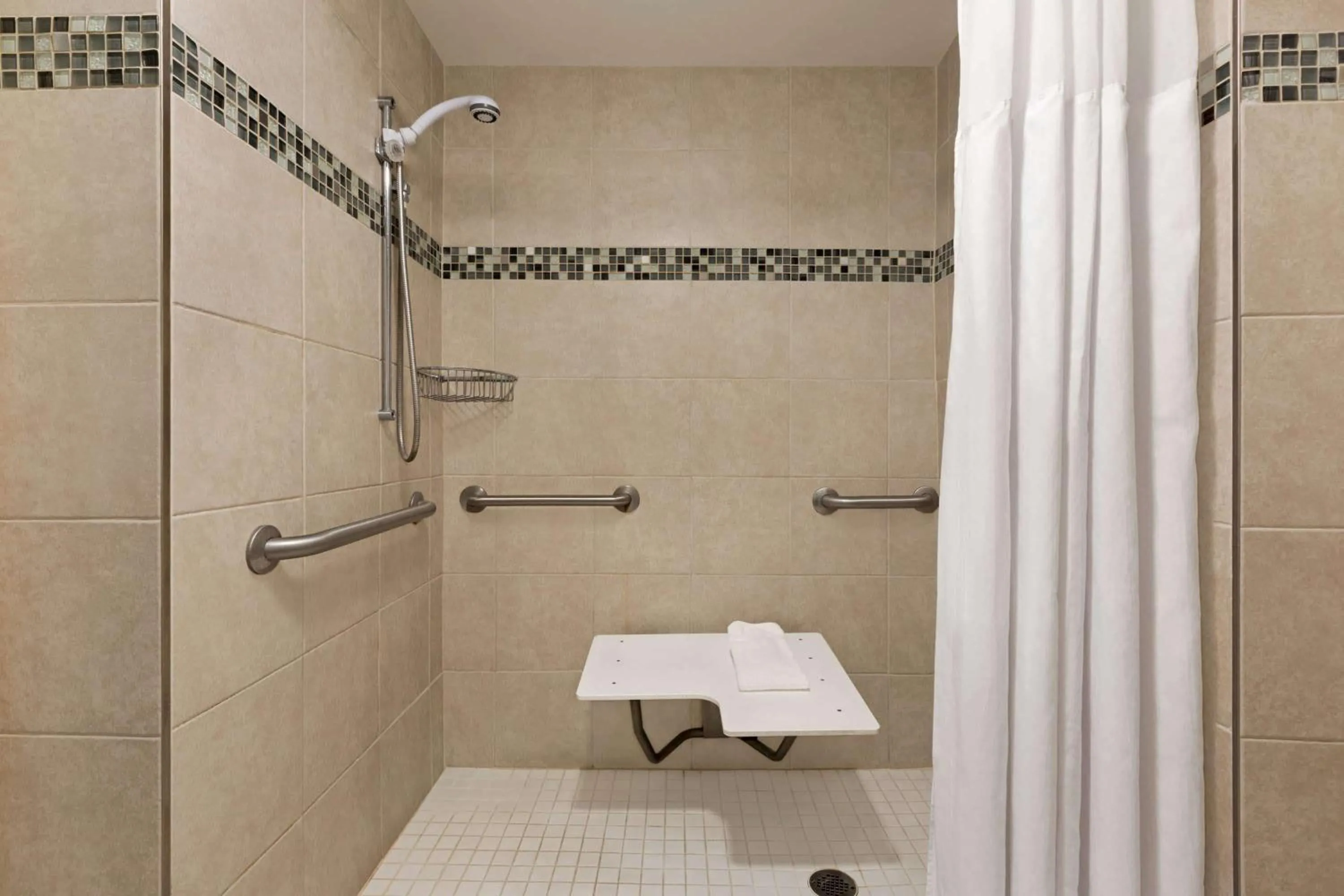 Shower in Ramada by Wyndham Suites Orlando Airport- Free Airport Shuttle