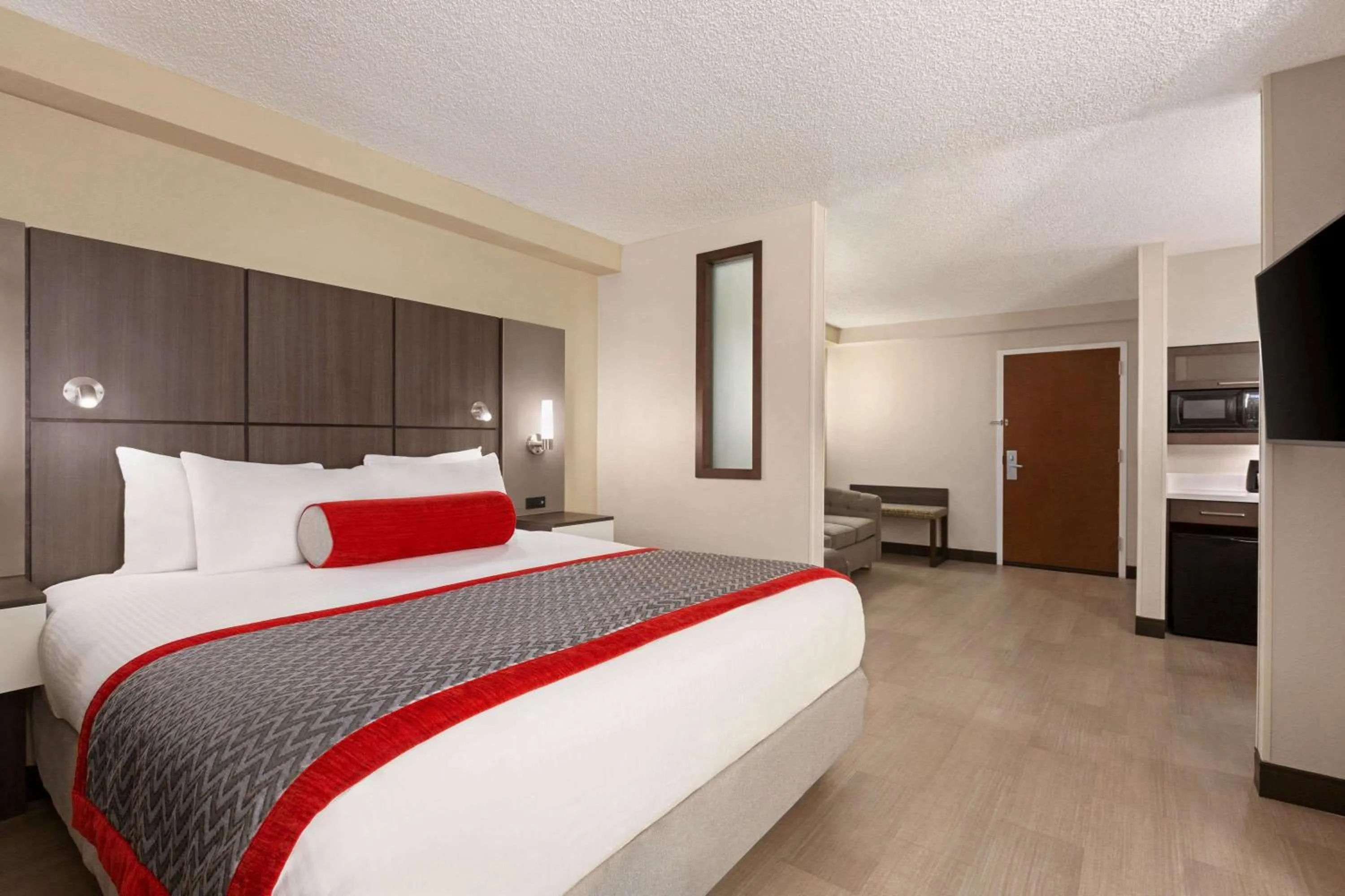 Photo of the whole room, Bed in Ramada by Wyndham Suites Orlando Airport- Free Airport Shuttle