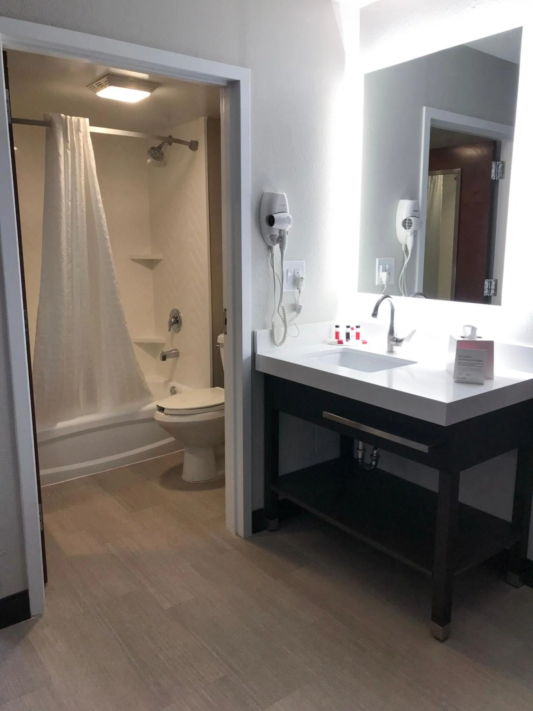 Bathroom in Ramada by Wyndham Suites Orlando Airport- Free Airport Shuttle