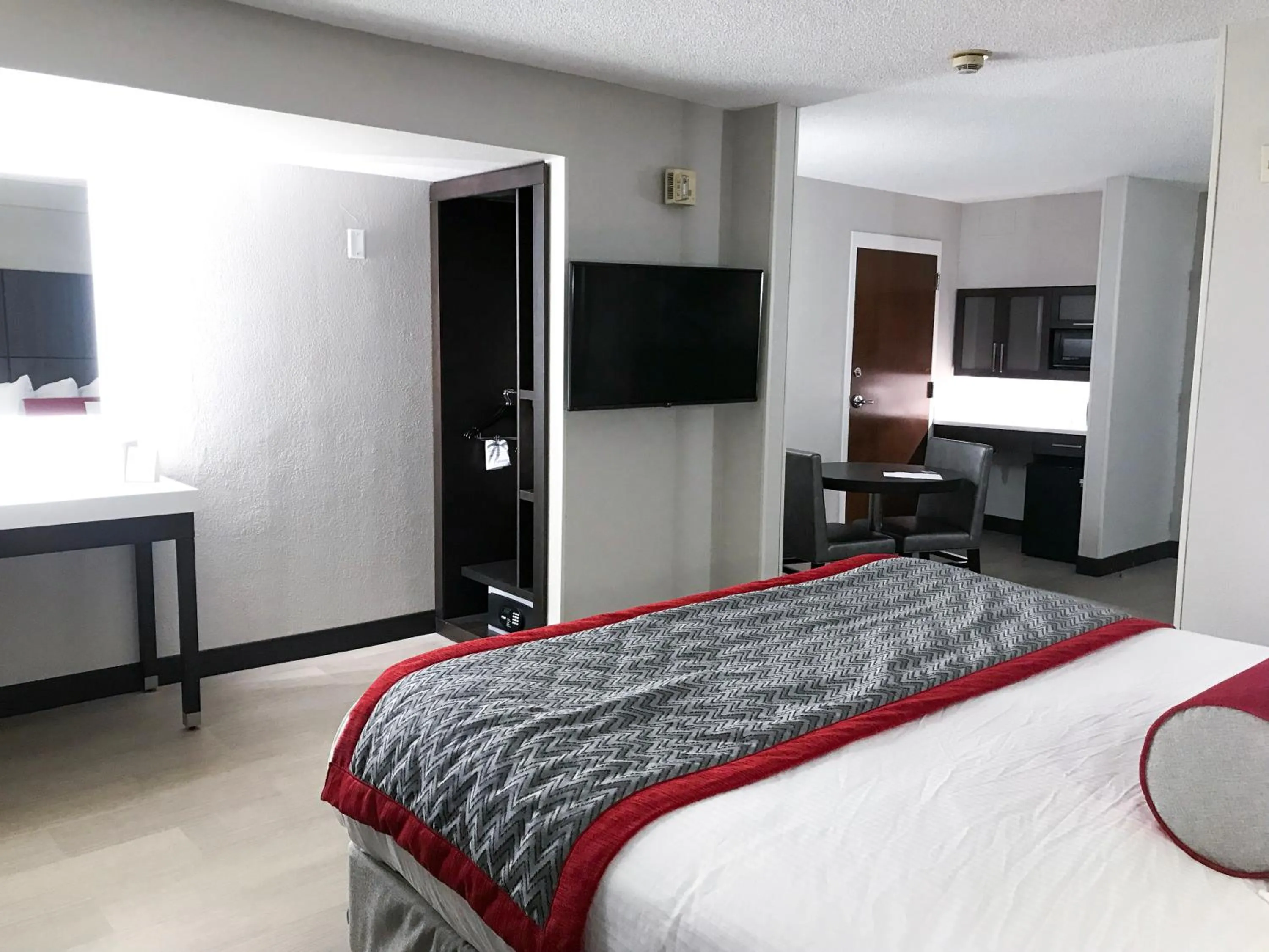 Photo of the whole room, Bed in Ramada by Wyndham Suites Orlando Airport- Free Airport Shuttle