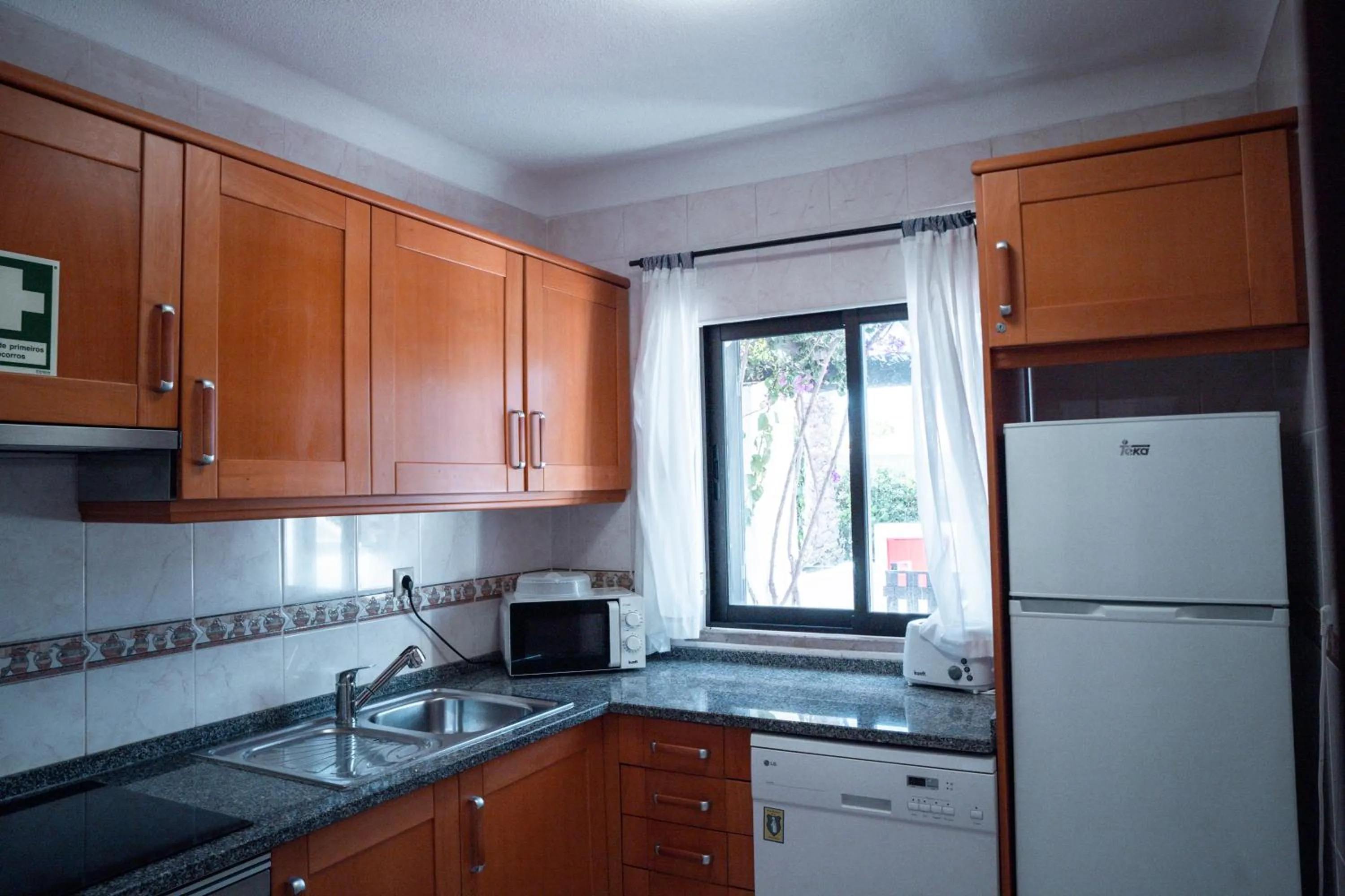 Kitchen or kitchenette in Apartamentos Honorio - Pool and Garden