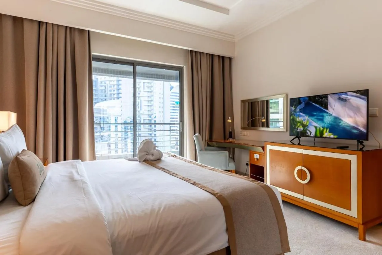 Bed in Grand Bellevue Hotel Apartment Dubai