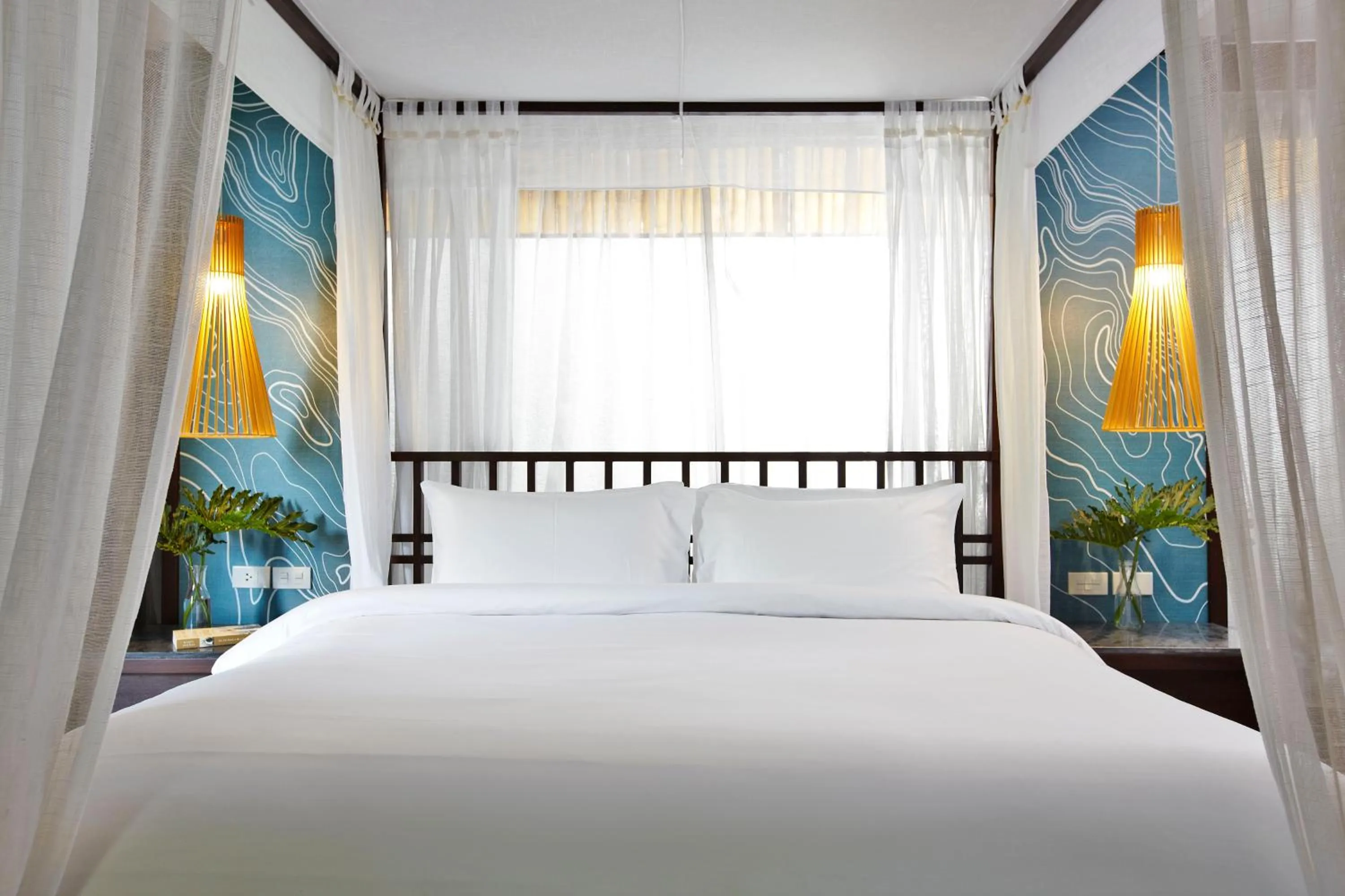 Bed in Sareeraya Villas & Suites