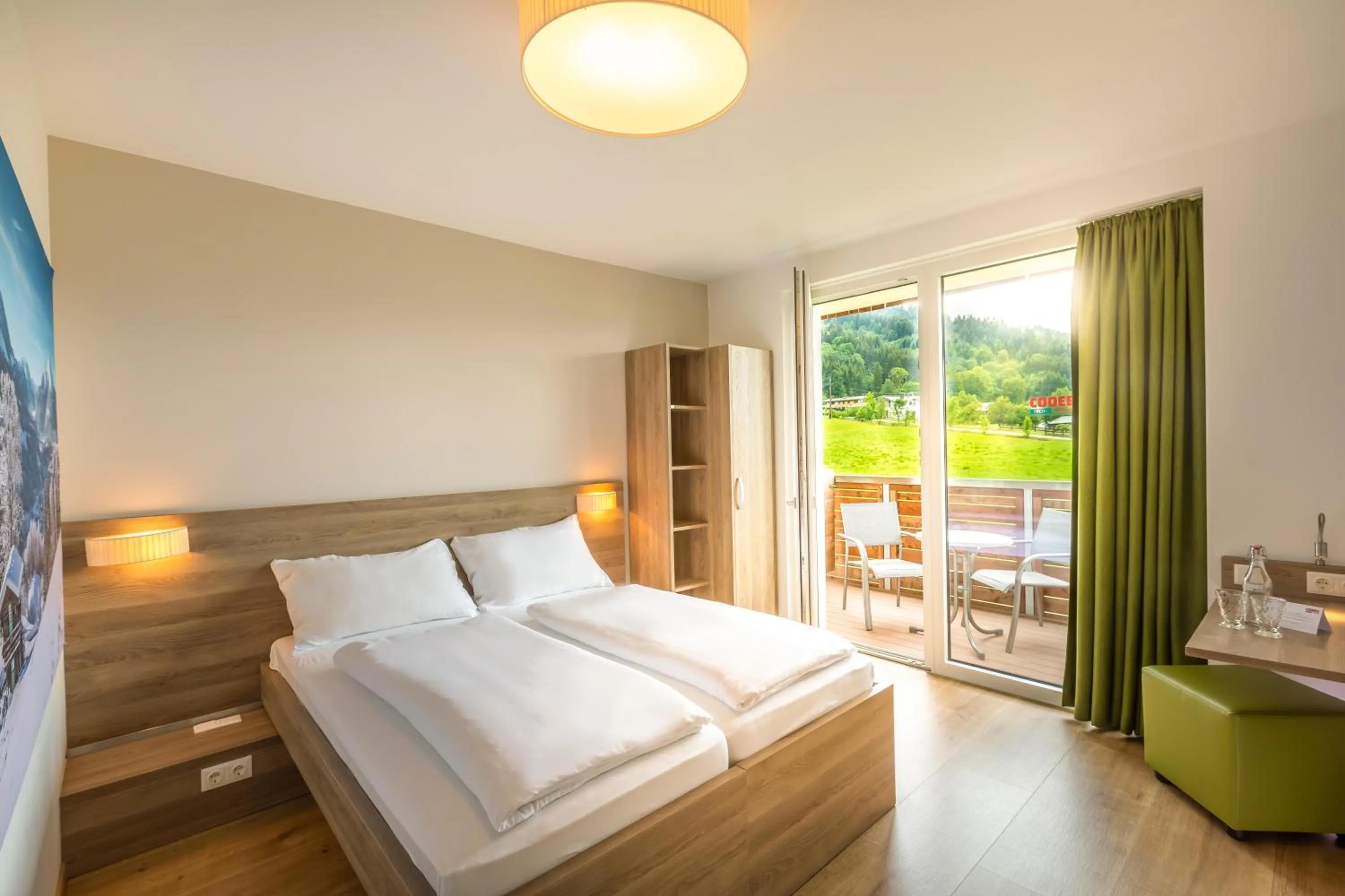 Bed in COOEE alpin Hotel Kitzbüheler Alpen