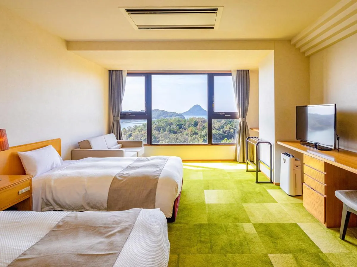 Bed in Ooedo Onsen Monogatari Amakusa Hotel Kameya