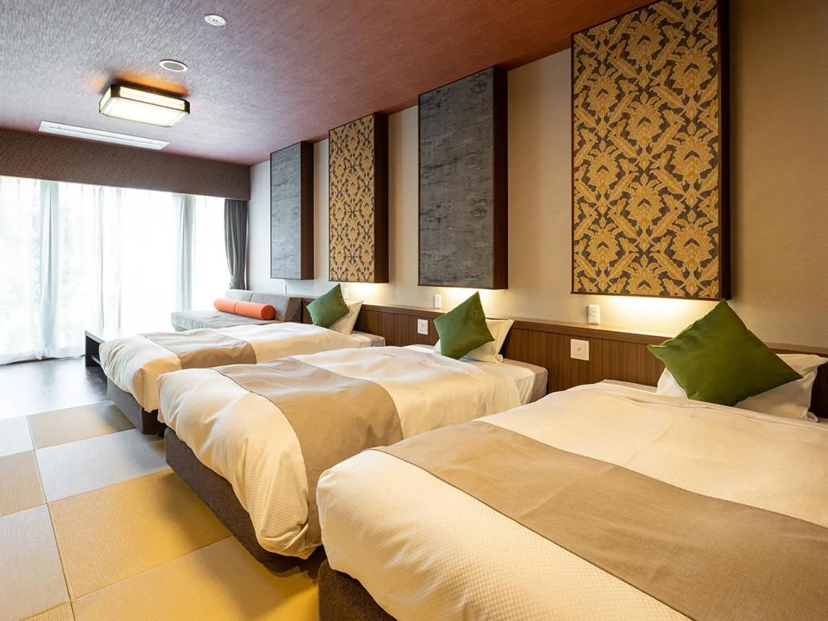 Bed in Ooedo Onsen Monogatari Amakusa Hotel Kameya