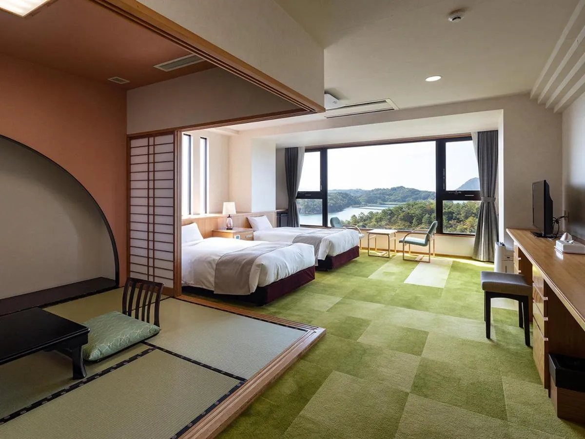 Bed in Ooedo Onsen Monogatari Amakusa Hotel Kameya