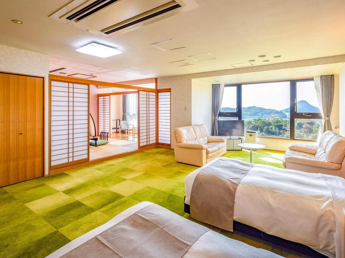 Bed in Ooedo Onsen Monogatari Amakusa Hotel Kameya