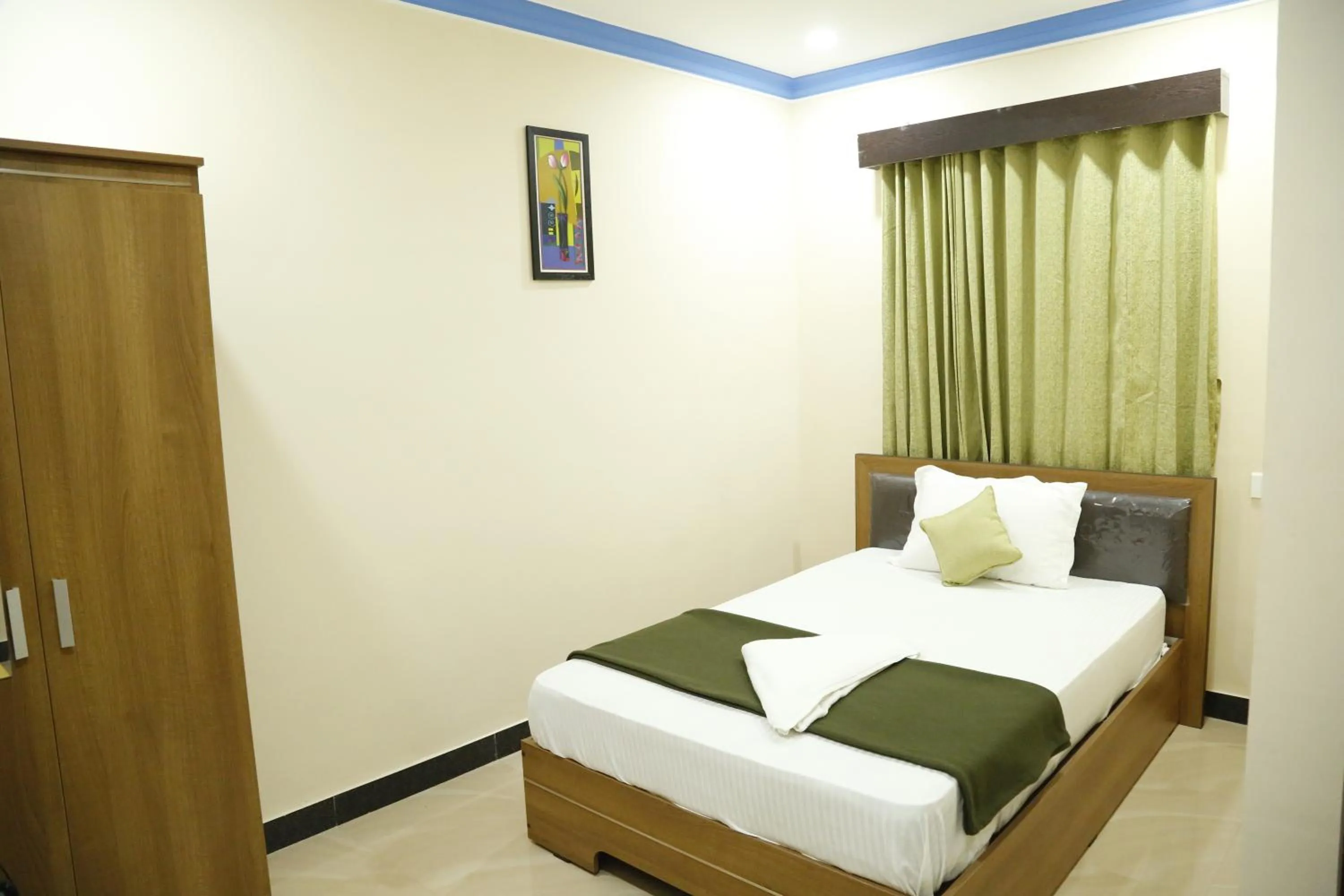 Bedroom in Hotel New Amirtham inn