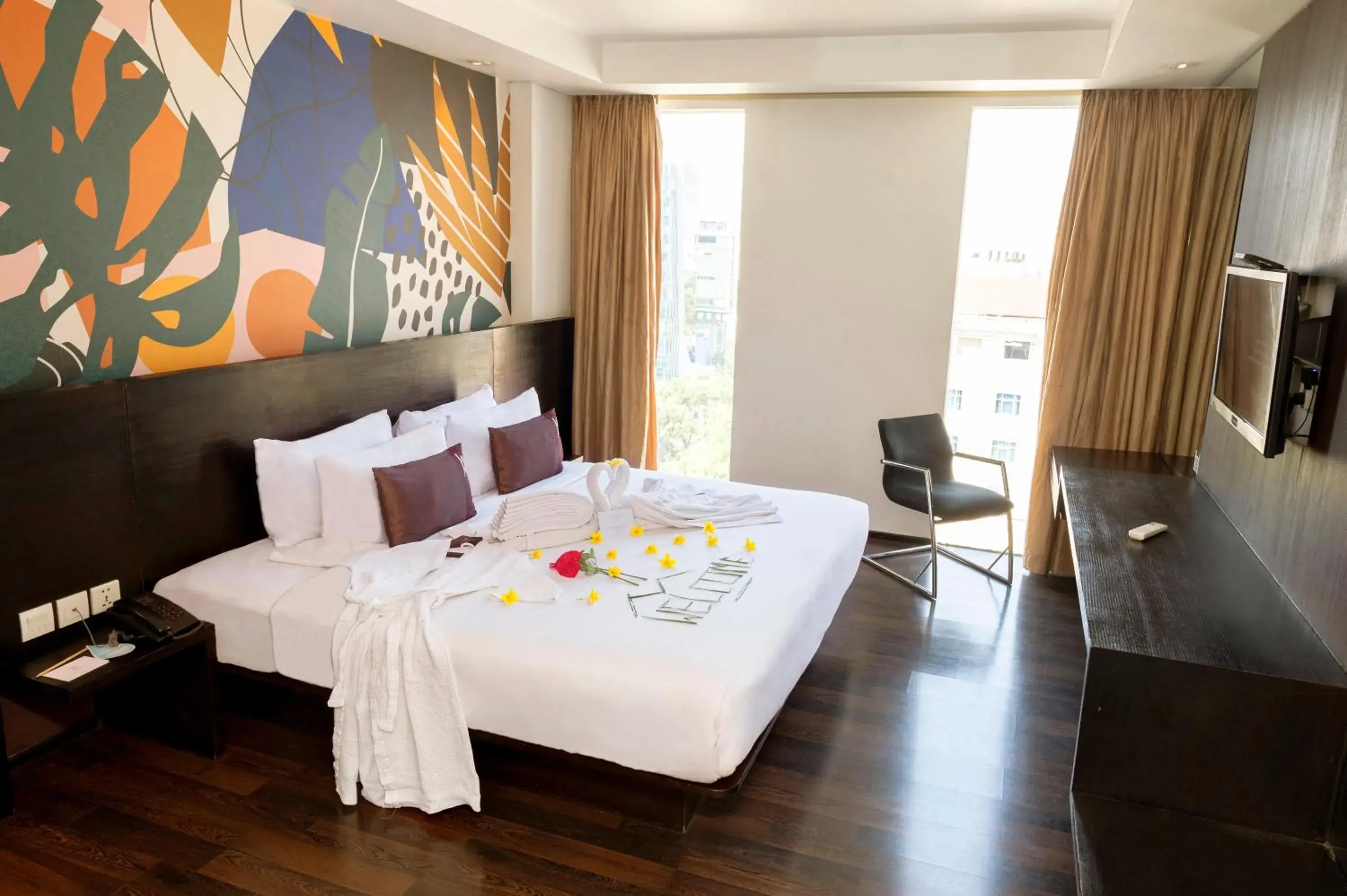 Communal lounge/ TV room, Bed in Akmani Hotel Jakarta Communal lounge/ TV room, Bed in Akmani Hotel Jakarta