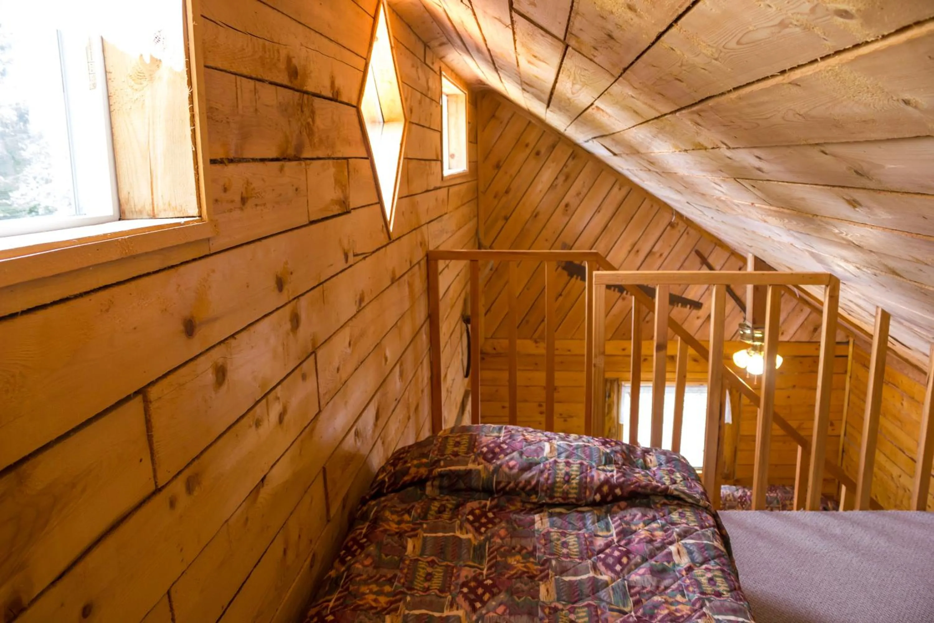 Bed in Midnight Sun Log Cabins