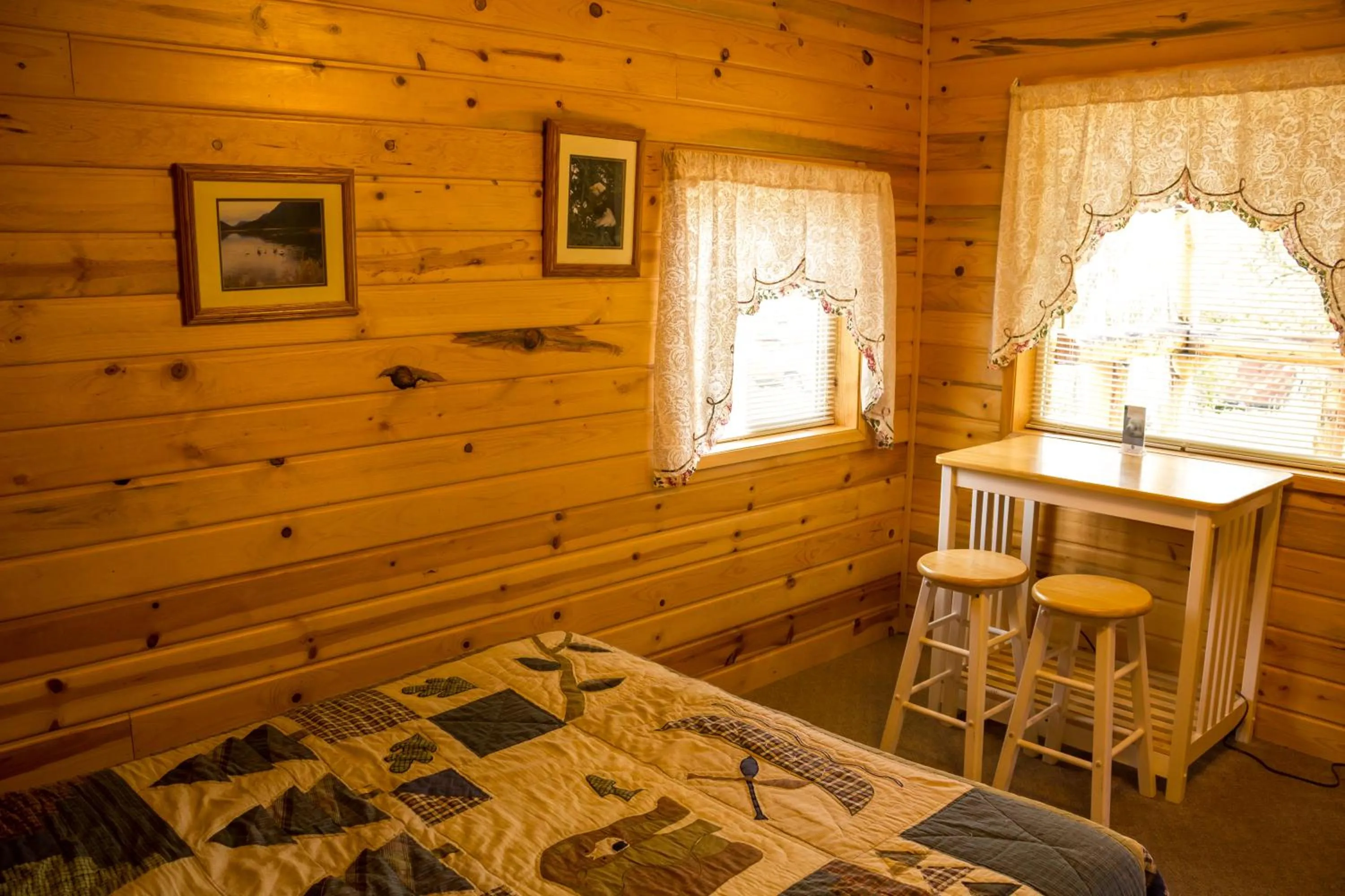 Bed in Midnight Sun Log Cabins