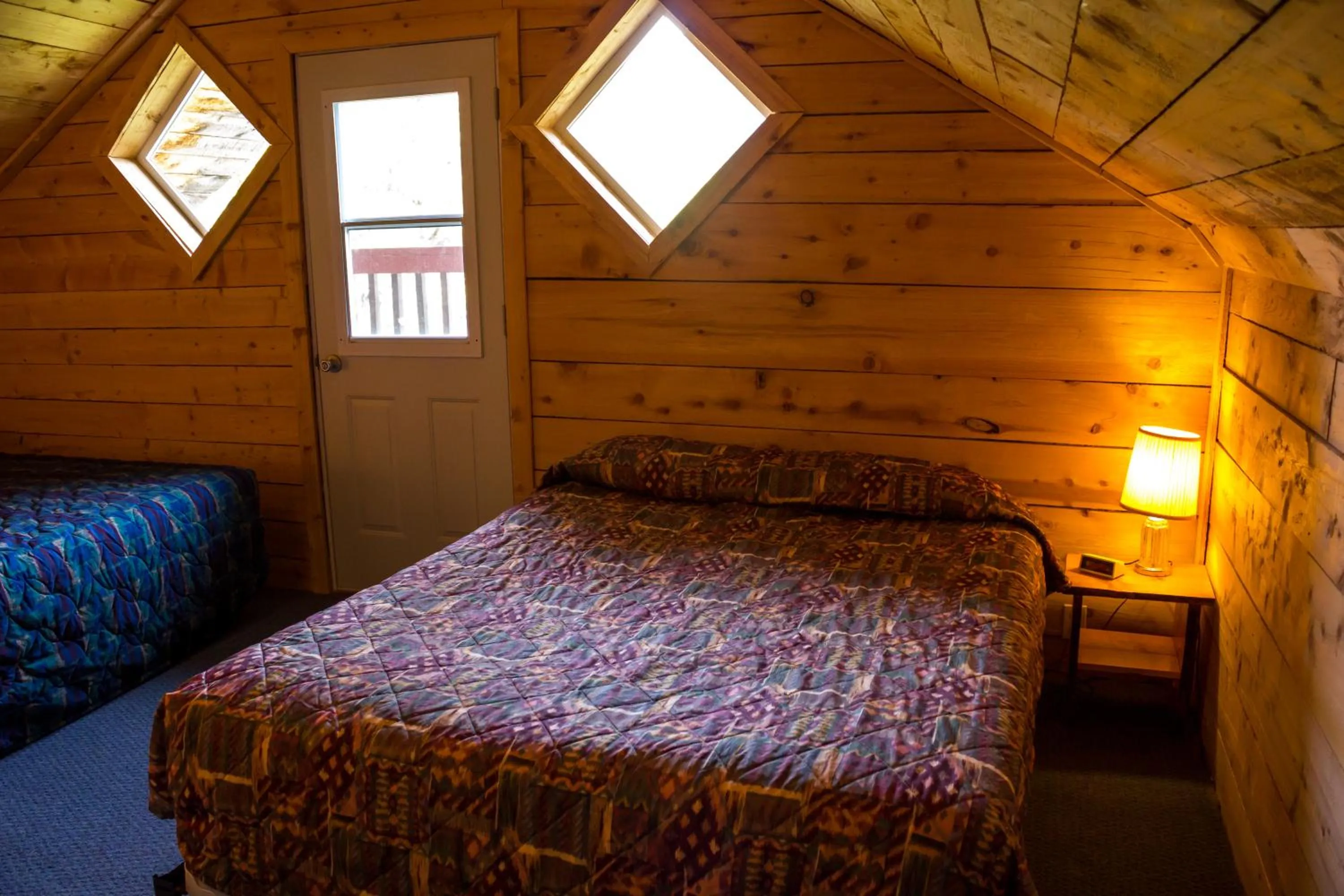 Bed in Midnight Sun Log Cabins