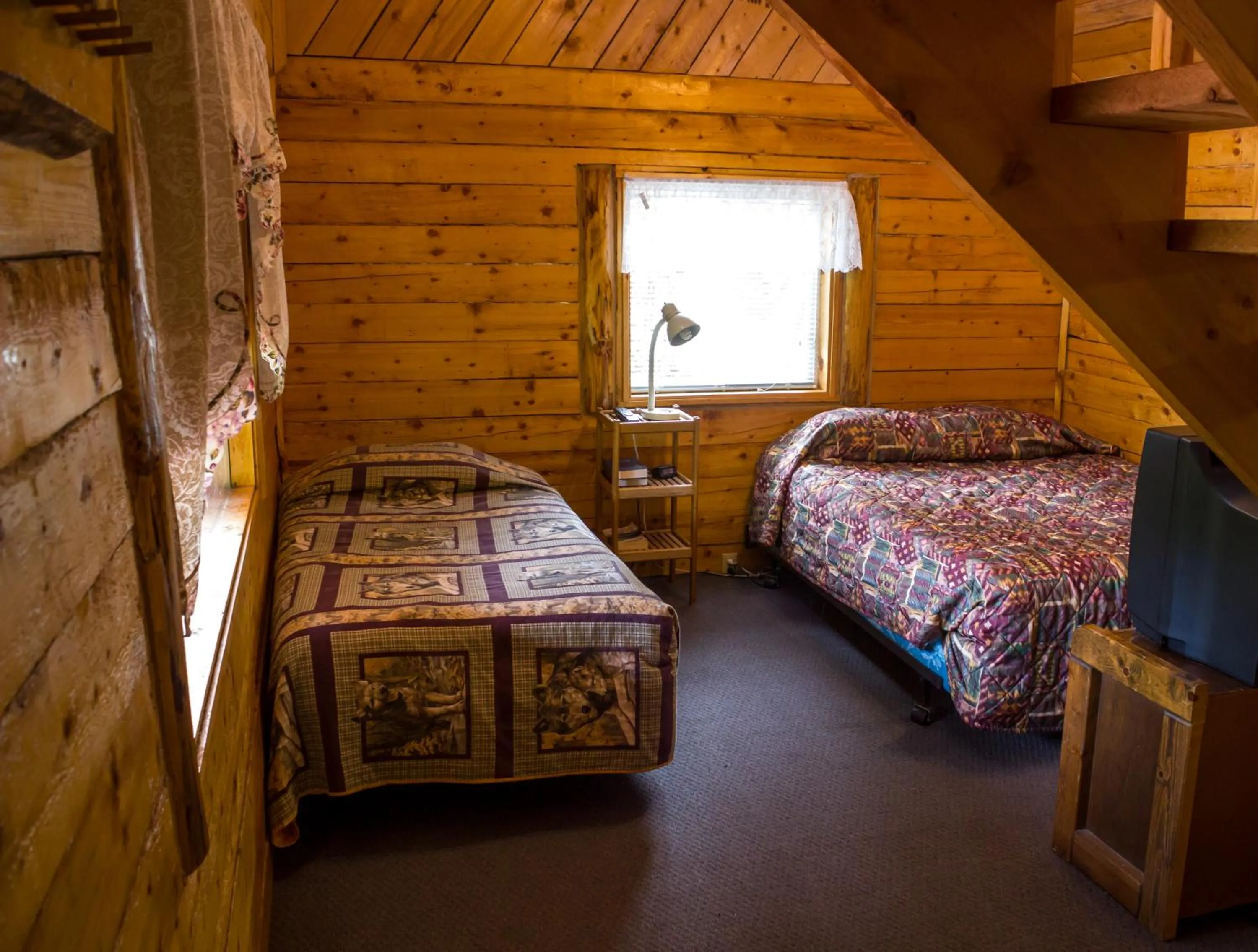 Bed in Midnight Sun Log Cabins