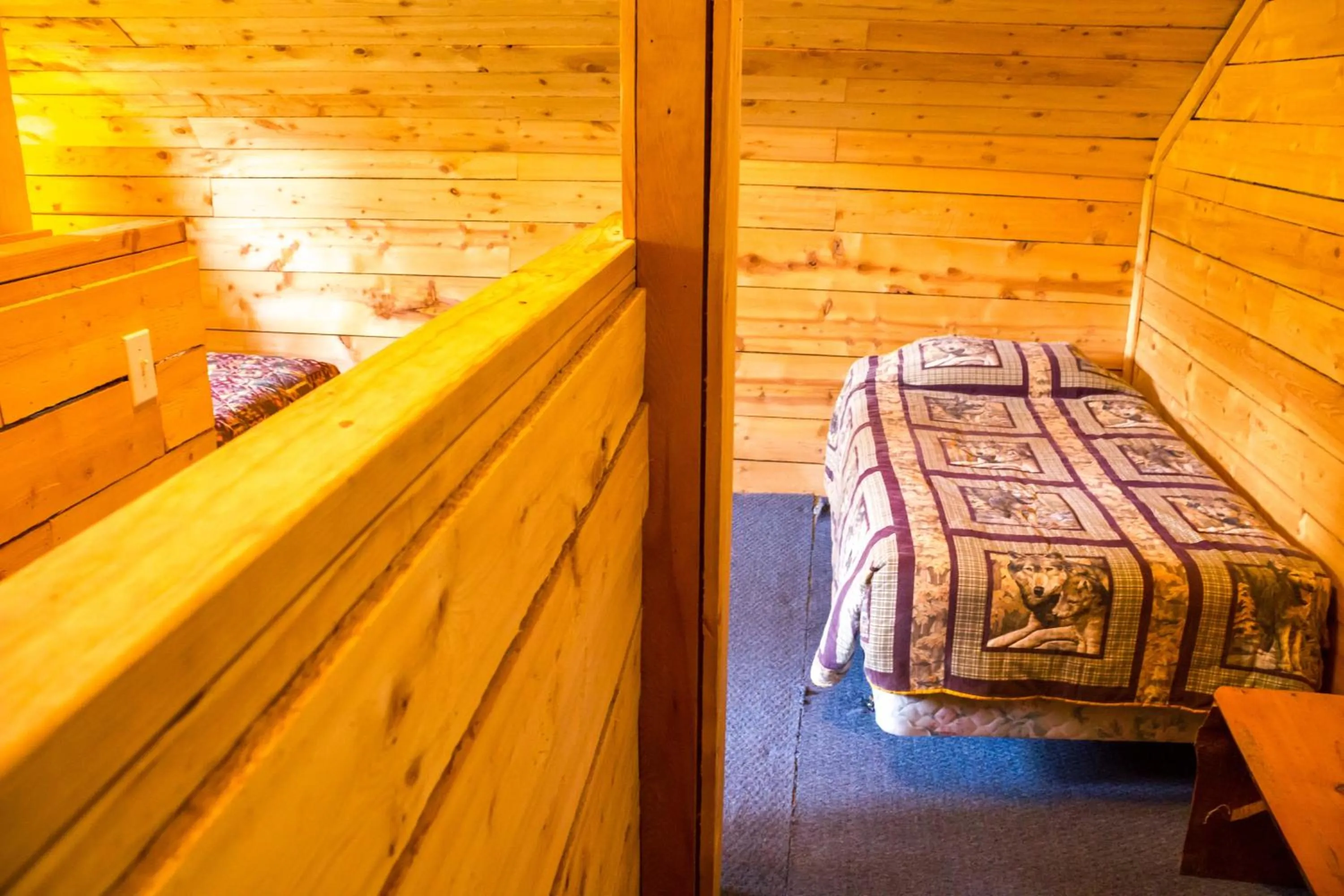 Bed in Midnight Sun Log Cabins