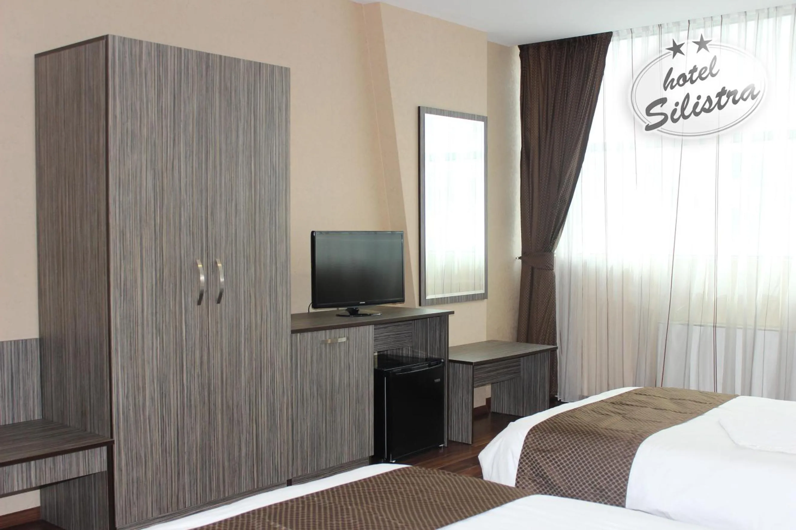 Text overlay, Bed in Family Hotel Silistra