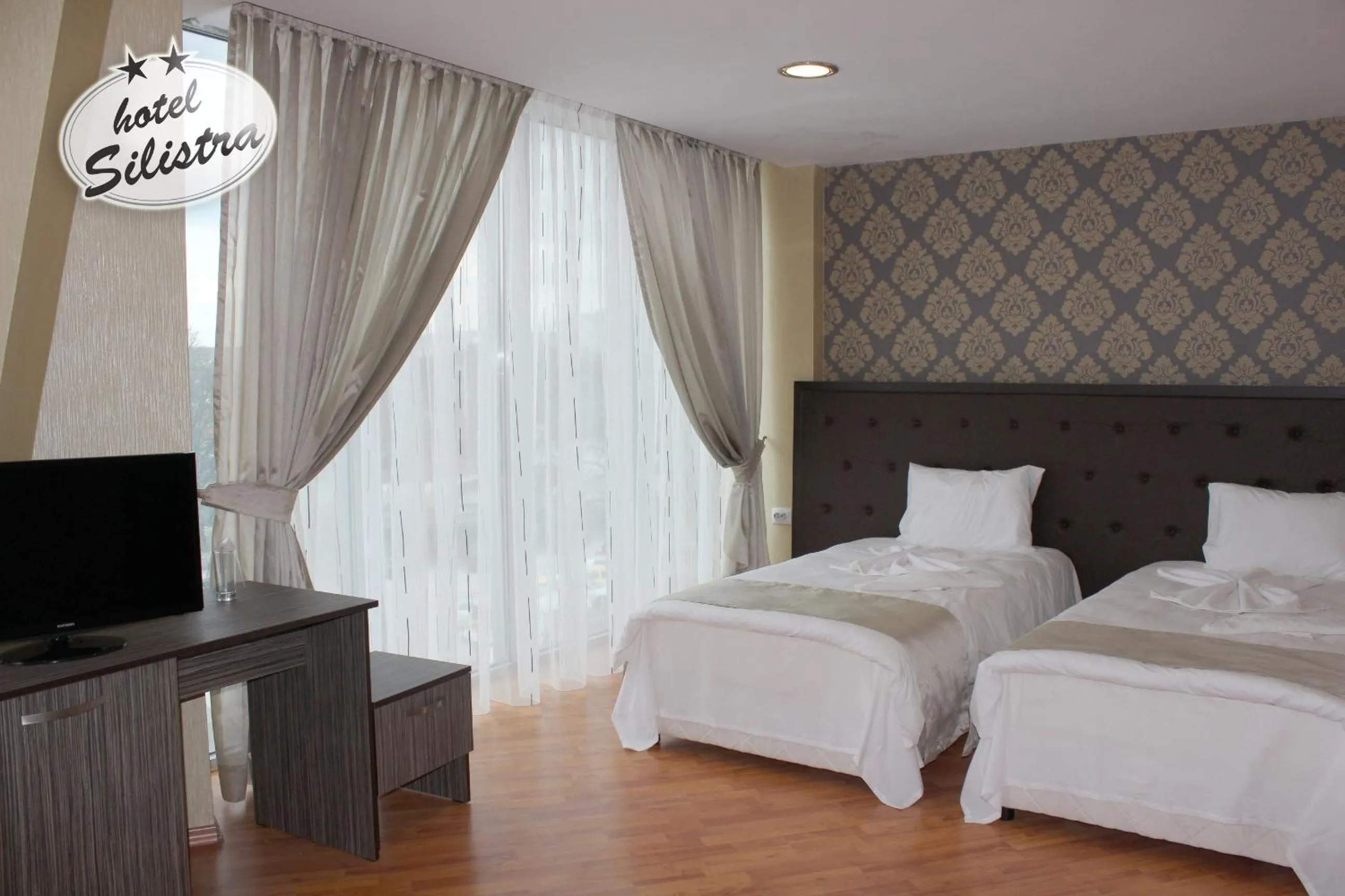 Text overlay, Bed in Family Hotel Silistra