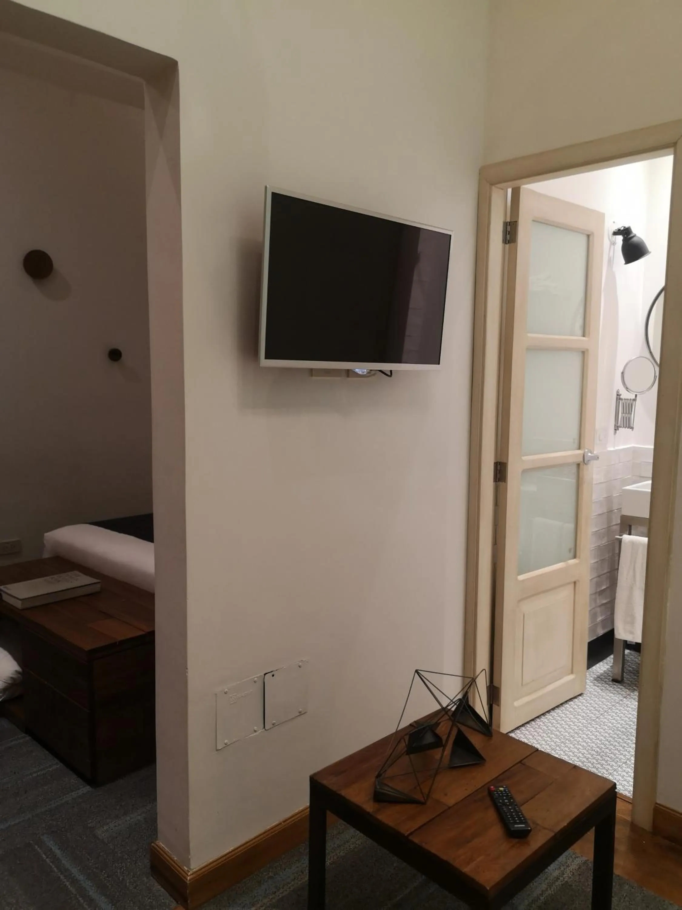 Communal lounge/ TV room, Bed in Carlota Sustainable Design Hotel