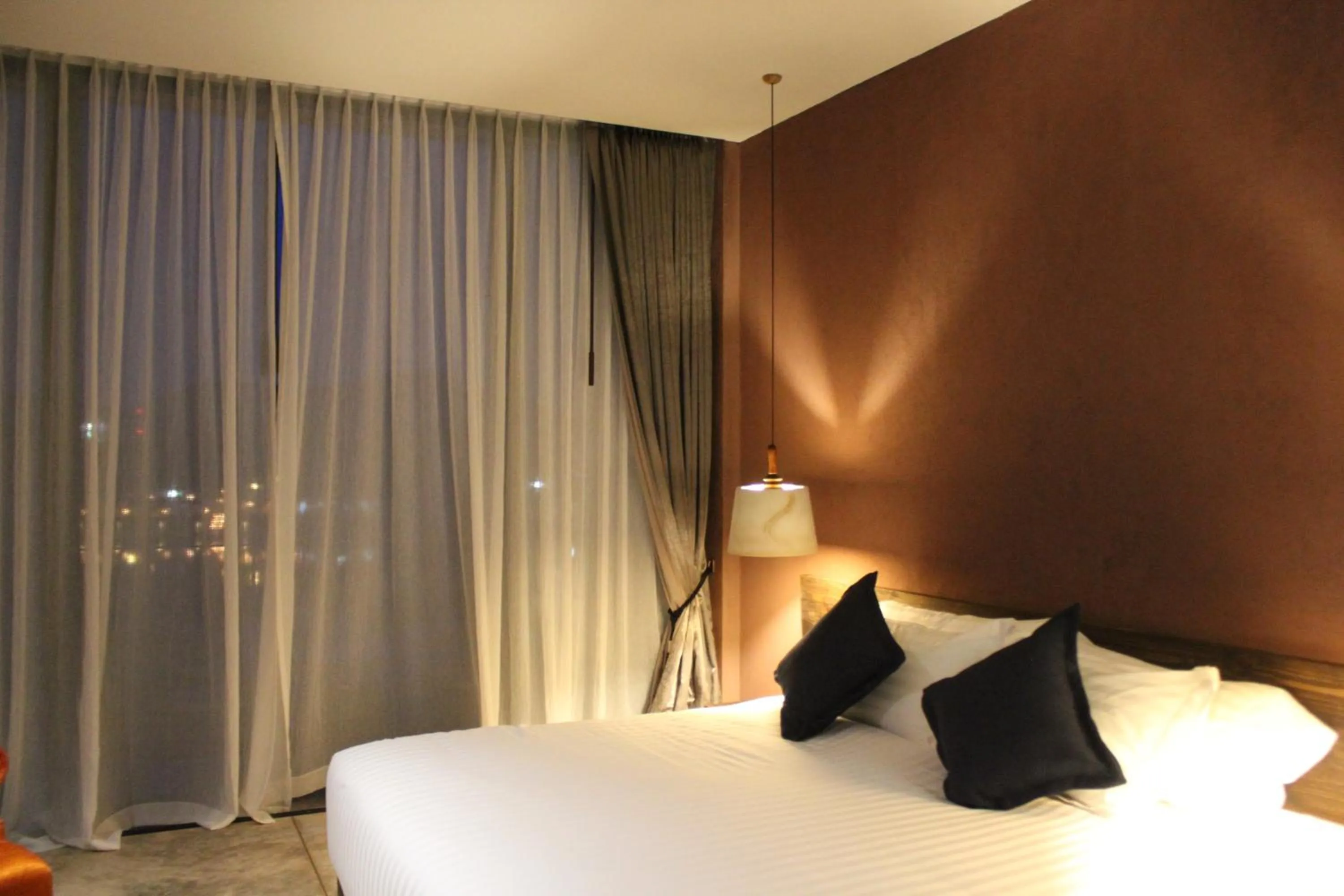 Bed in The Glory River Kwai Hotel