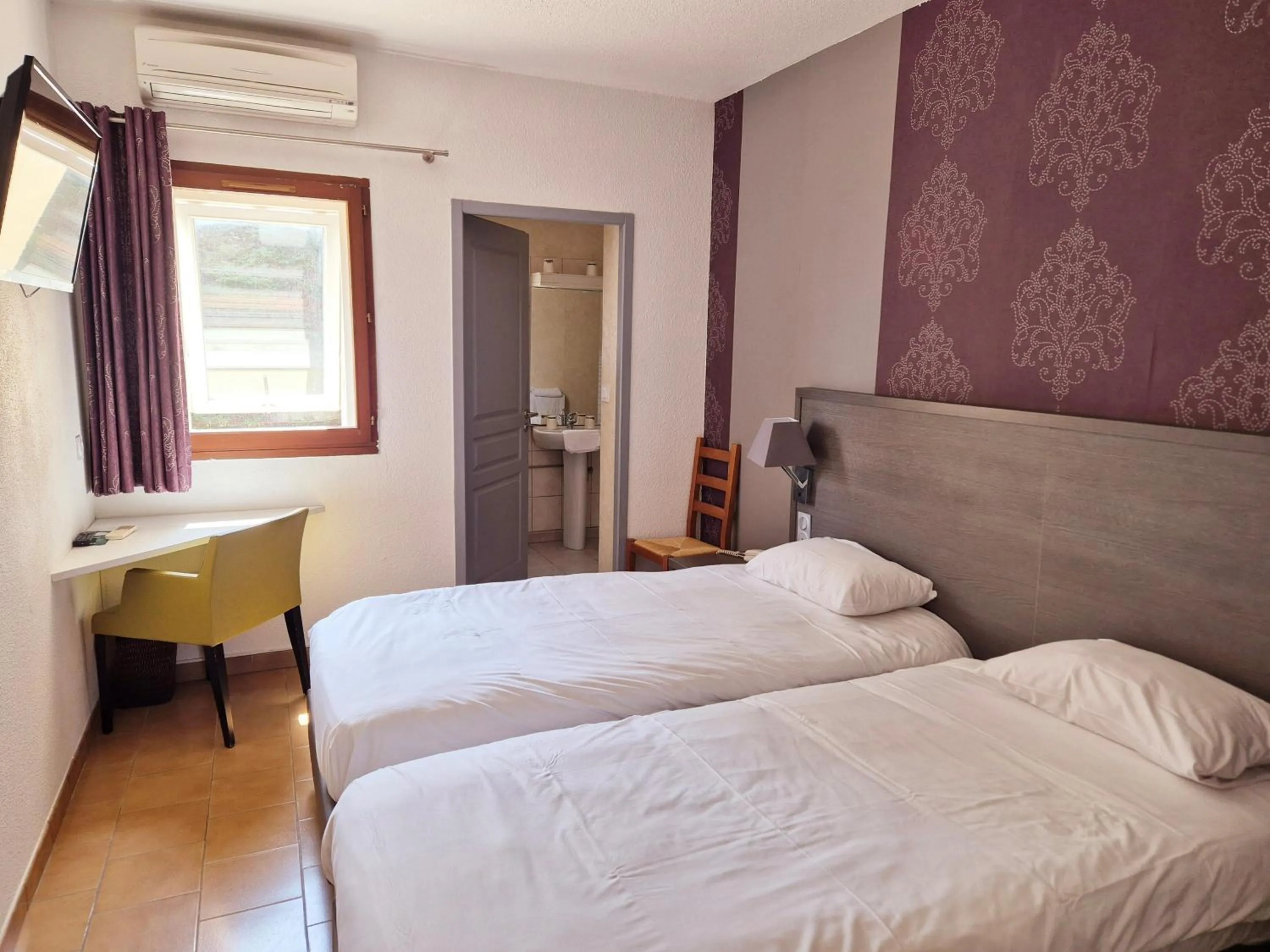 Bed in Logis Hôtel Le Mistral - Restaurant - Montélimar Sud