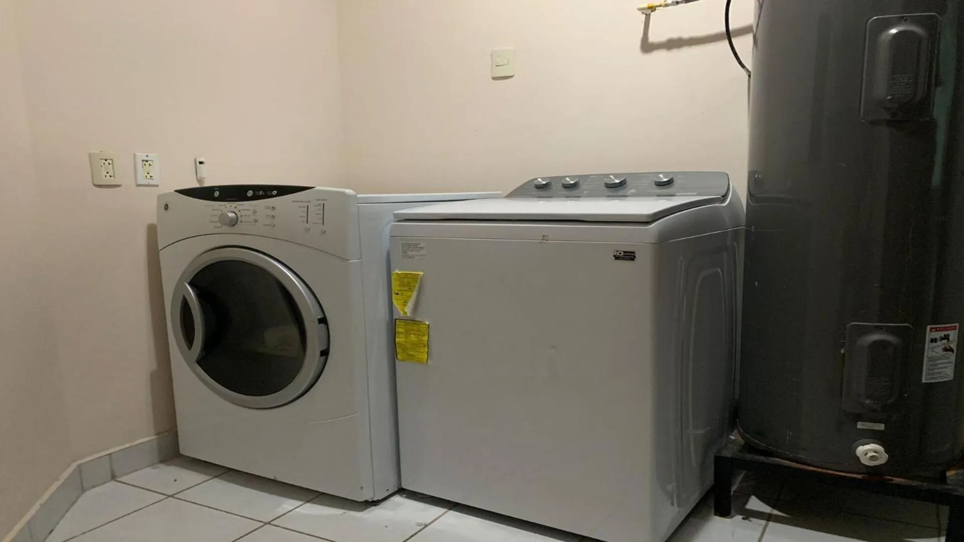 washing machine in Encanto Living Penthouse by Kivoya