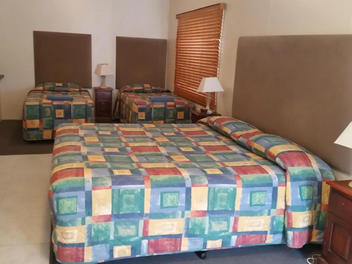Bed in Augathella Palms Motel