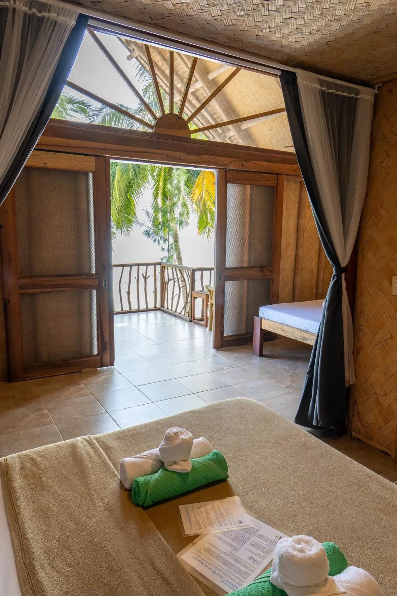 Bed in Sangat Island Dive Resort Bed in Sangat Island Dive Resort