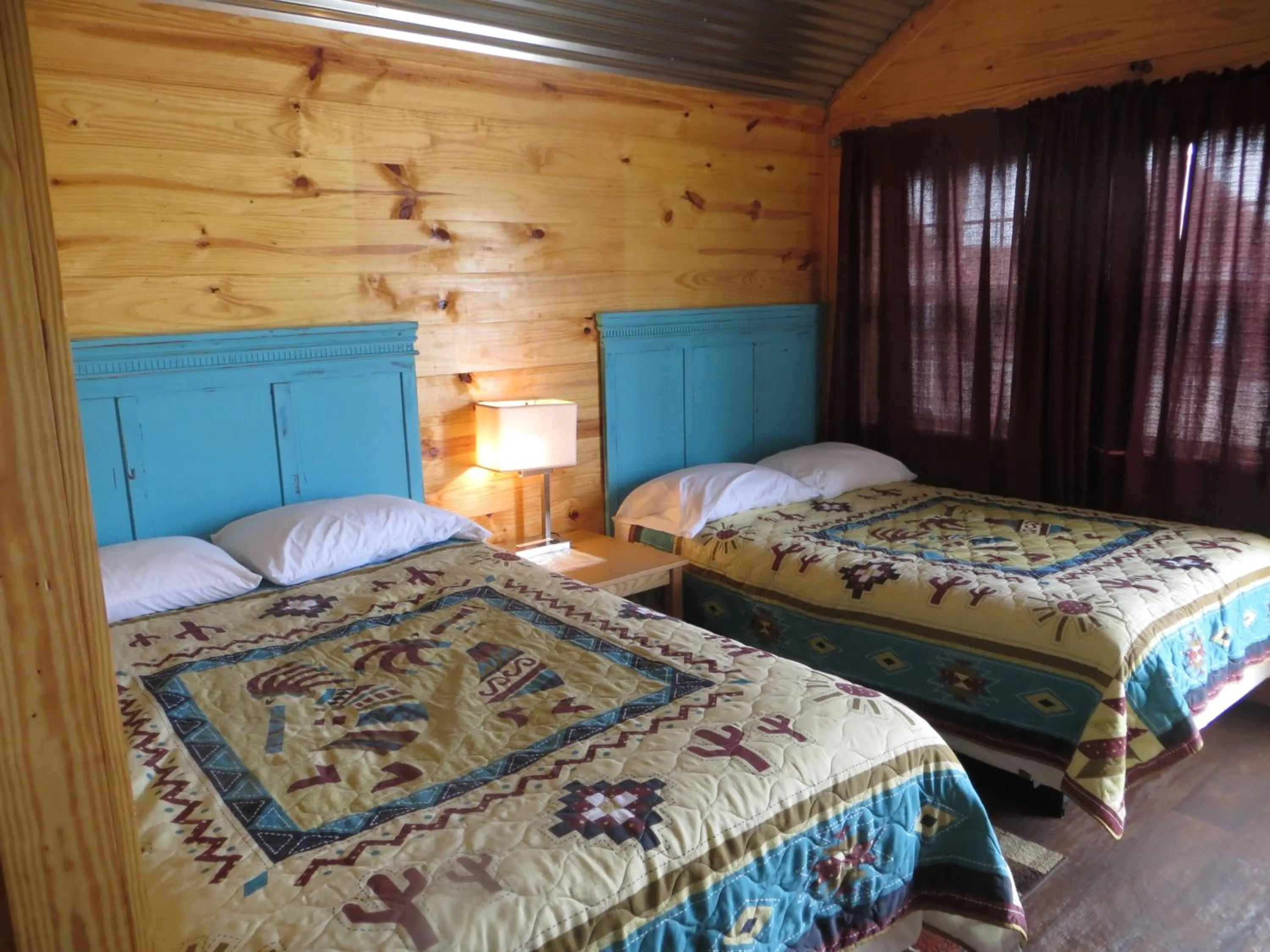 Bed in All Tucked Inn Cabins