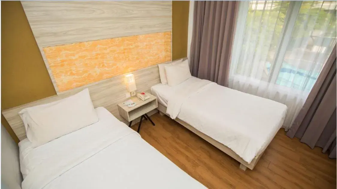 Bed in Front One Akshaya Hotel Karawang Bed in Front One Akshaya Hotel Karawang