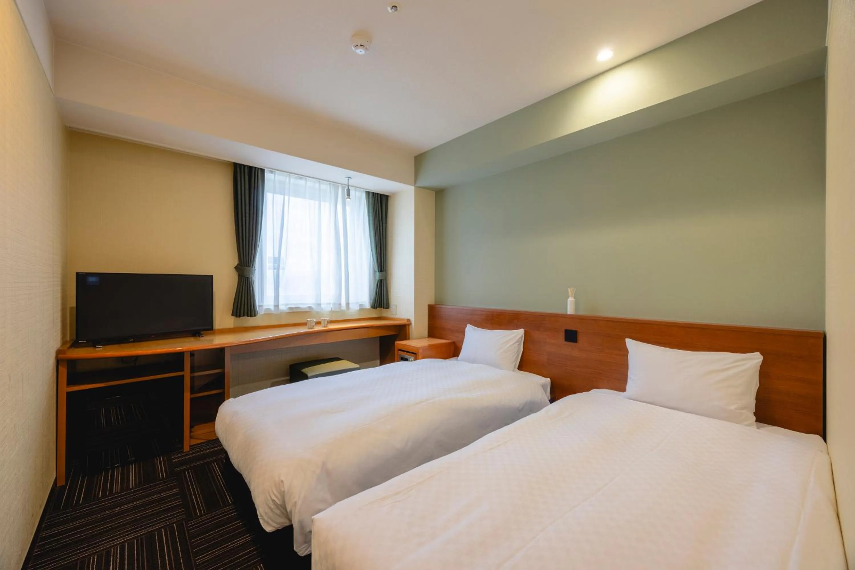 Bed in Kanku Izumiotsu Washington Hotel