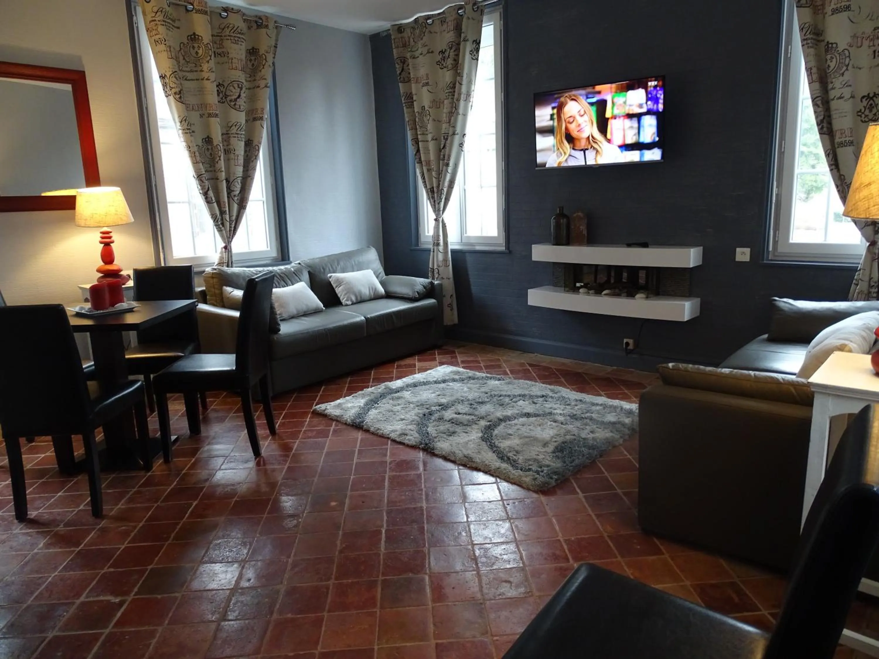 Communal lounge/ TV room in Logis Hôtel Restaurant Spa L'auberge Du President