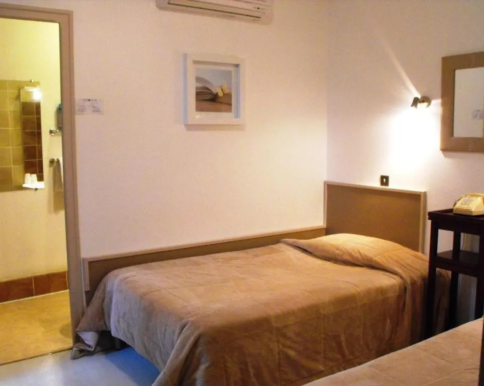 Photo of the whole room, Bed in Logis Hôtel Restaurant Les Capucins