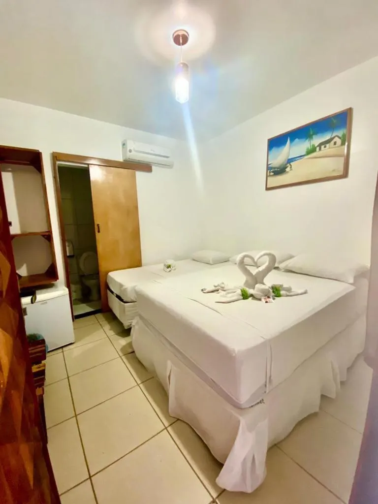 Bed in Pousada Quatro Irmãos