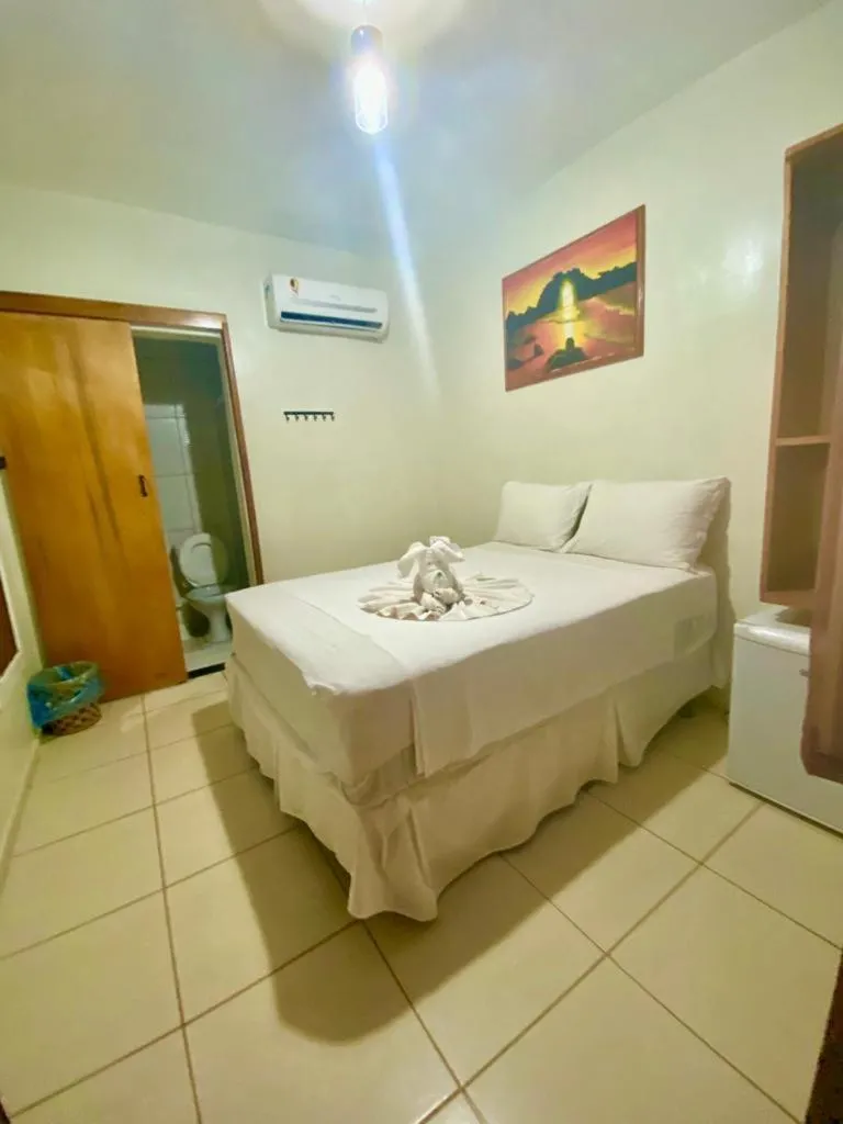 Bed in Pousada Quatro Irmãos