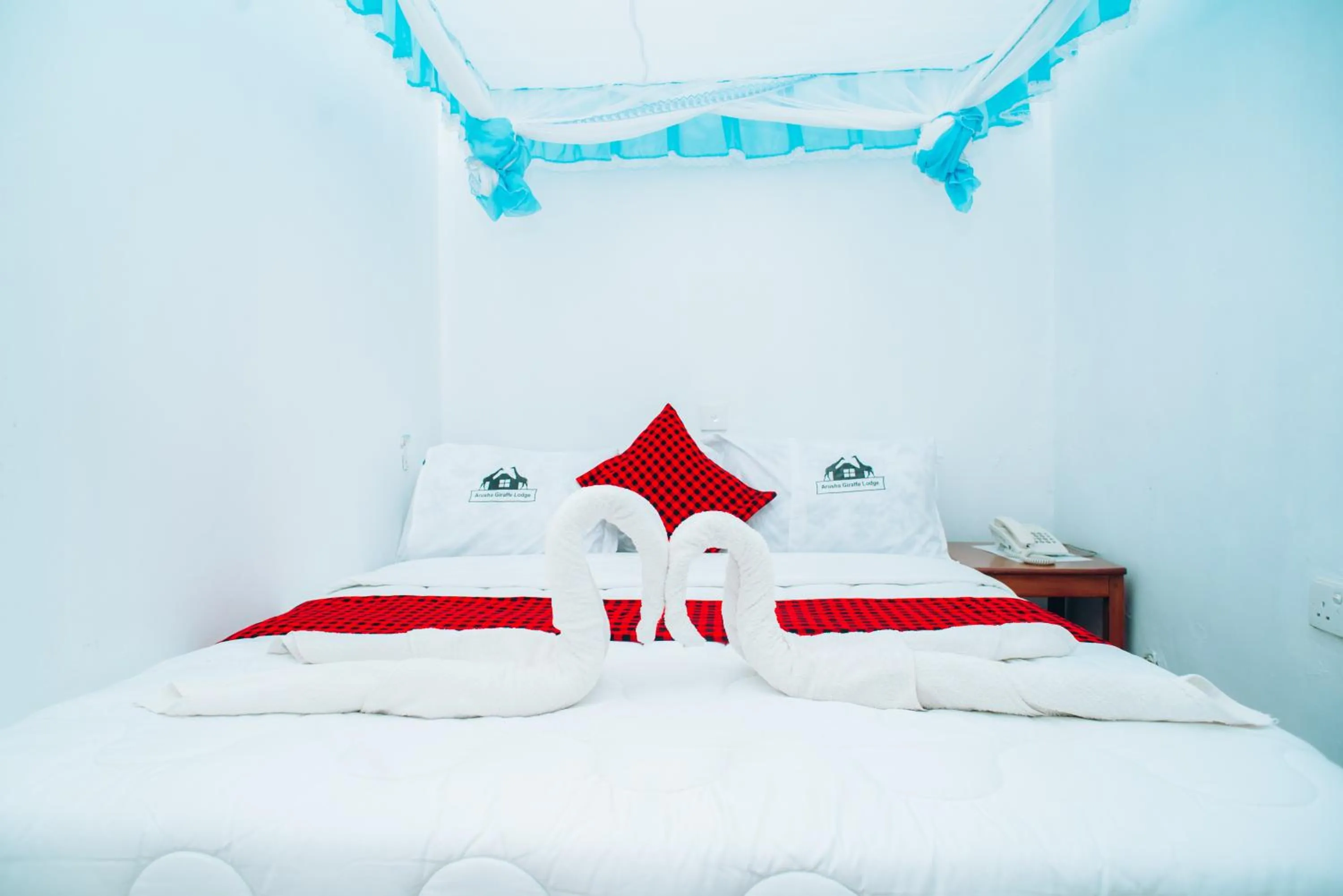 Bed in Arusha Giraffe Lodge