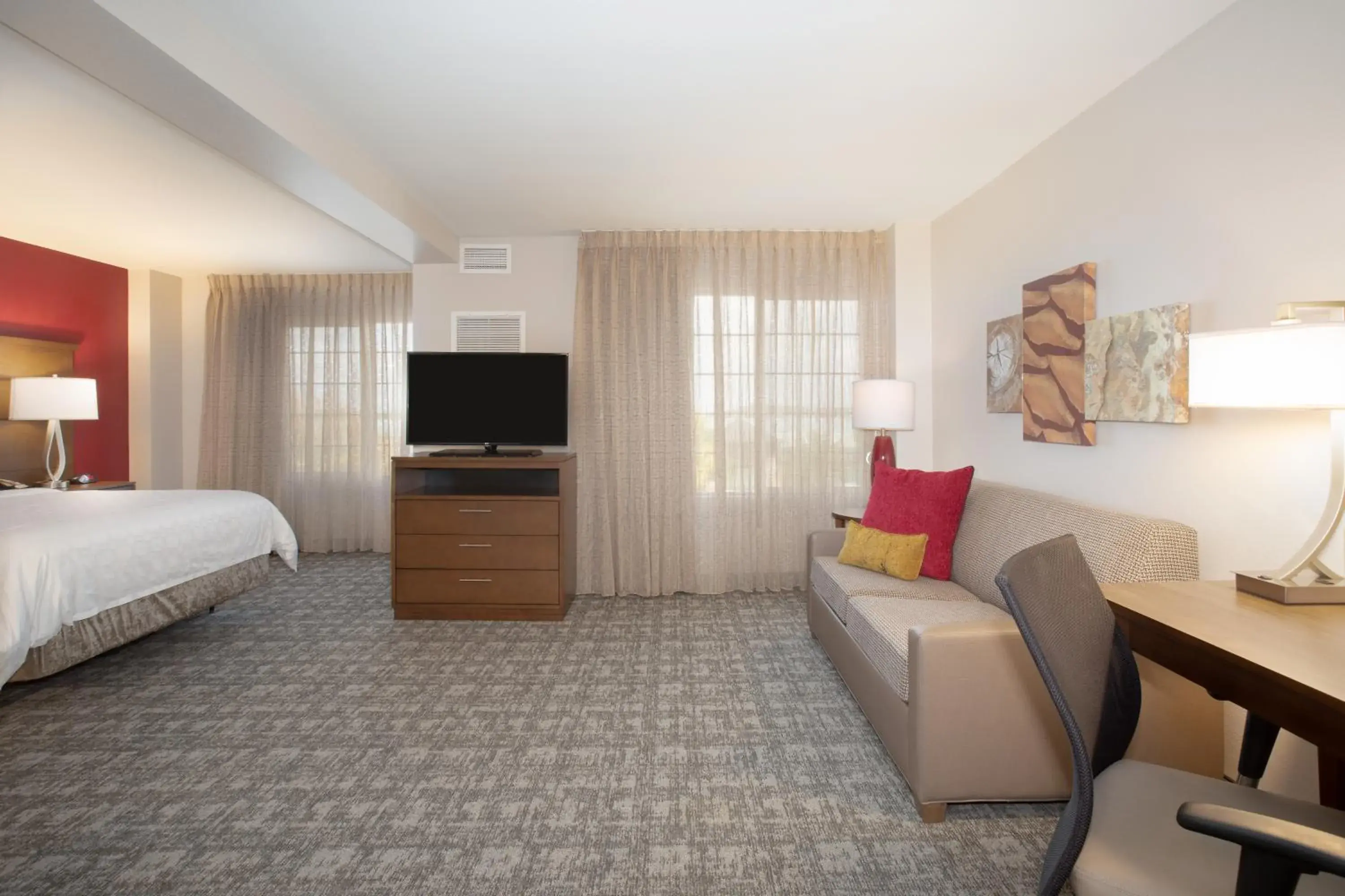 Seating area, Bed in Staybridge Suites Denver International Airport by IHG Seating area, Bed in Staybridge Suites Denver International Airport by IHG