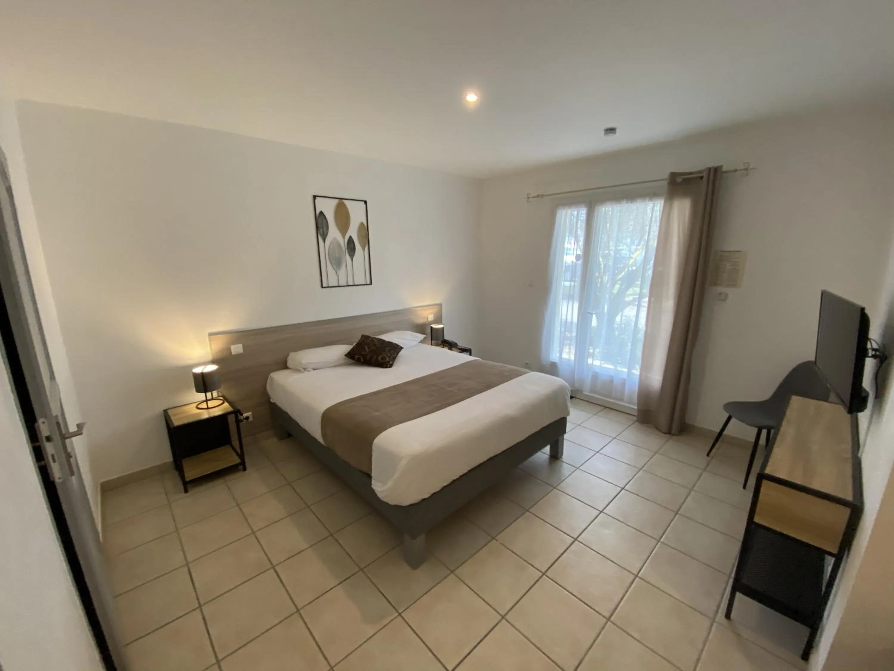 Bed in Logis Hôtel L'Oliveraie