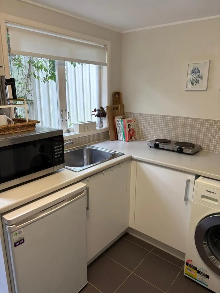 Kitchen or kitchenette in Jacaranda House Garden Suite