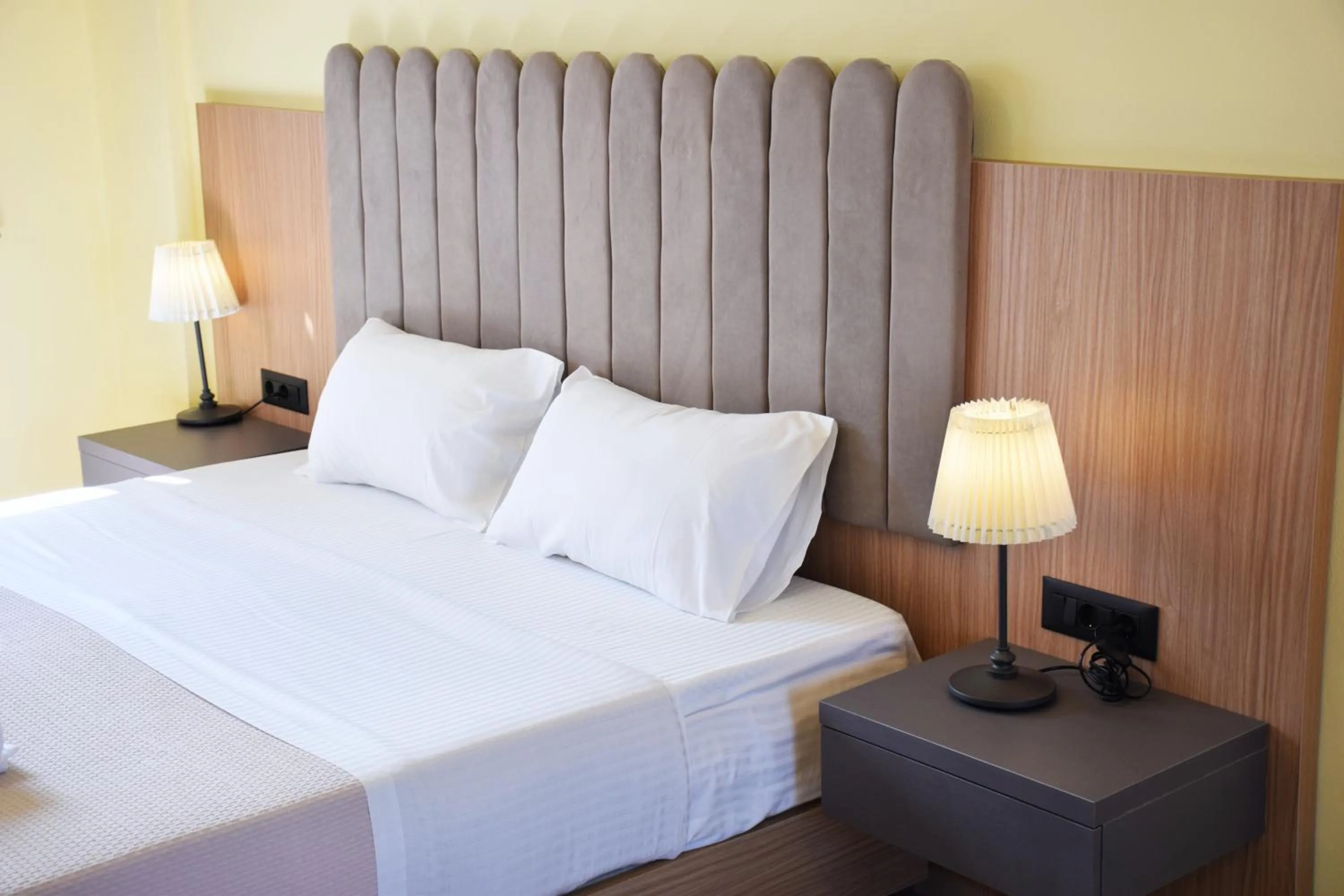 Bed in Eden Beach Hotel