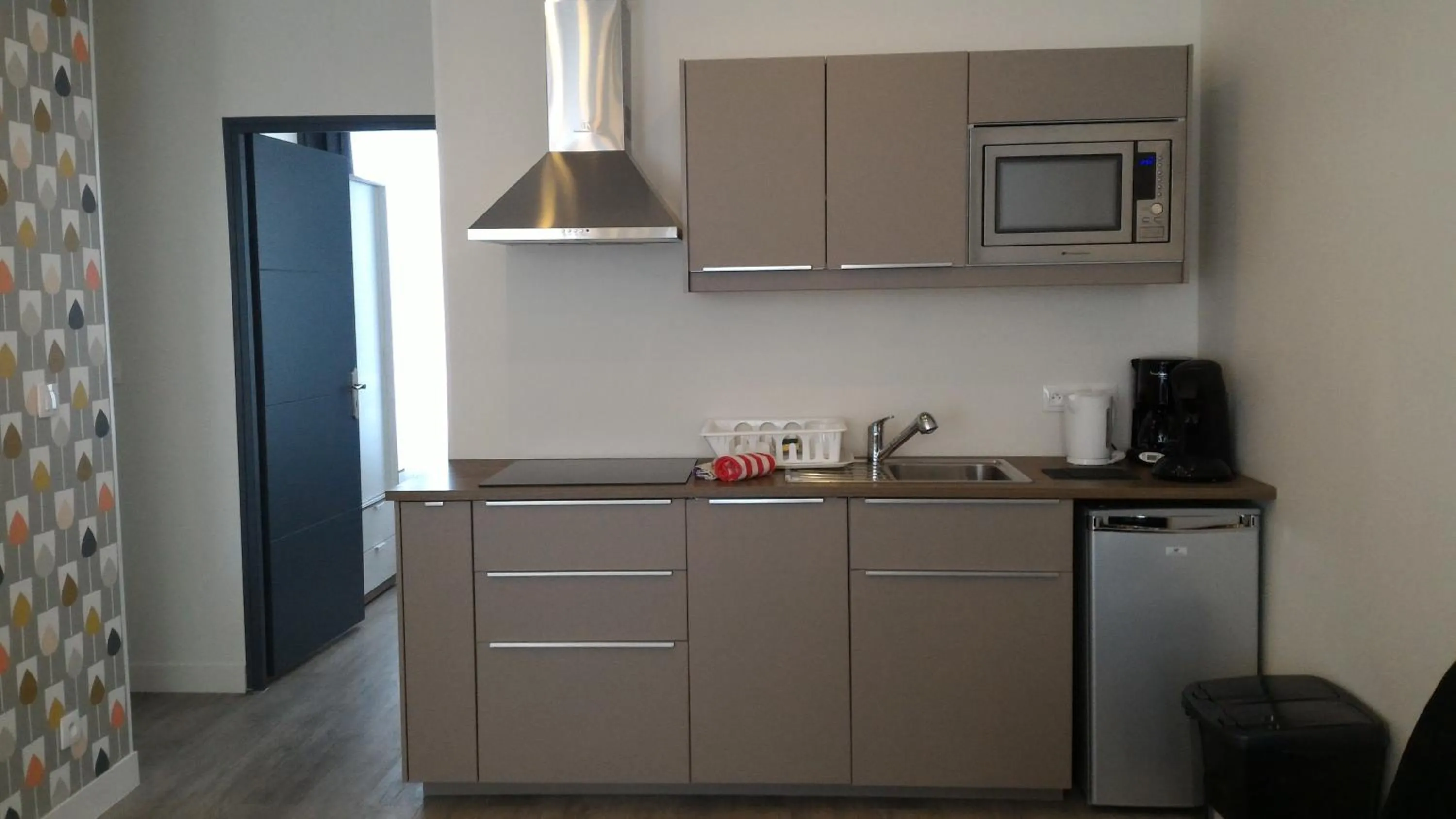 Kitchen or kitchenette in Sohosuite