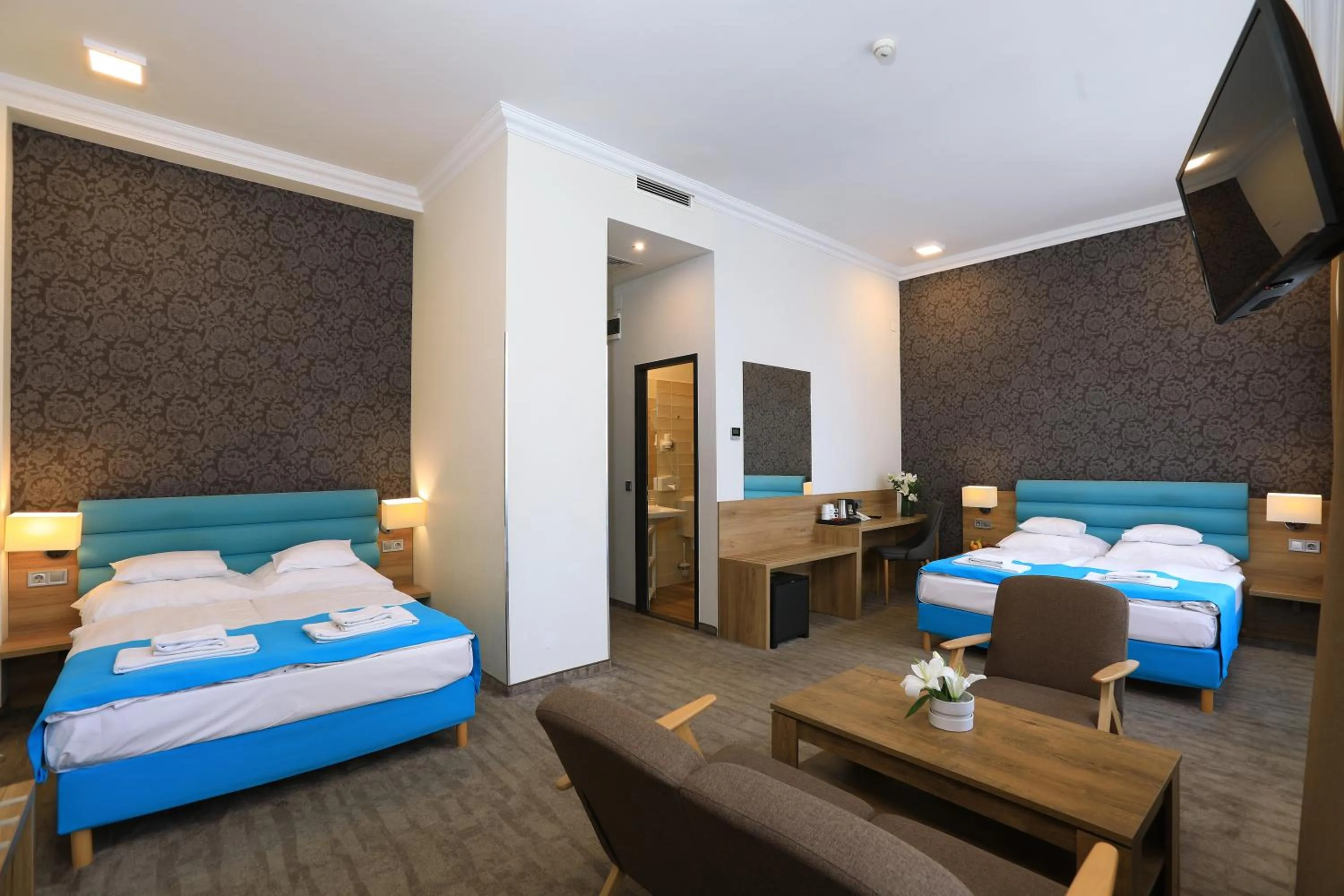 Communal lounge/ TV room, Bed in Medos Hotel