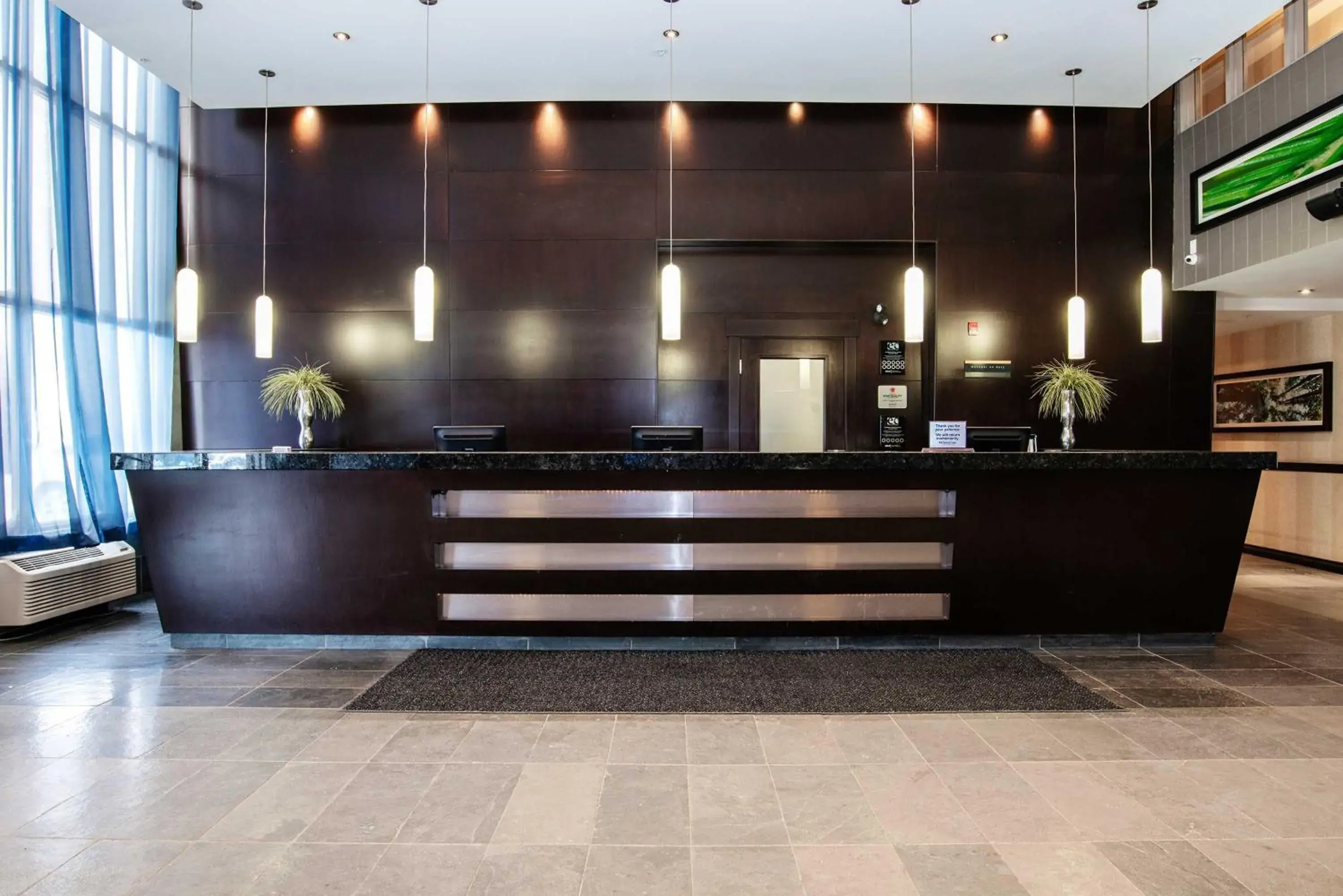 Lobby or reception in Sandman Hotel & Suites Calgary West Lobby or reception in Sandman Hotel & Suites Calgary West