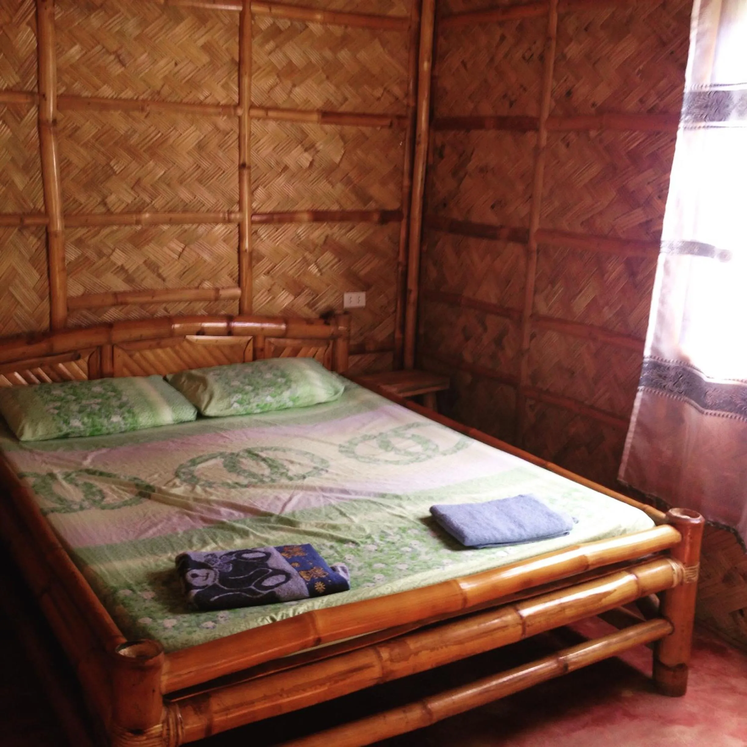 Bed in Calayo Beach Resort