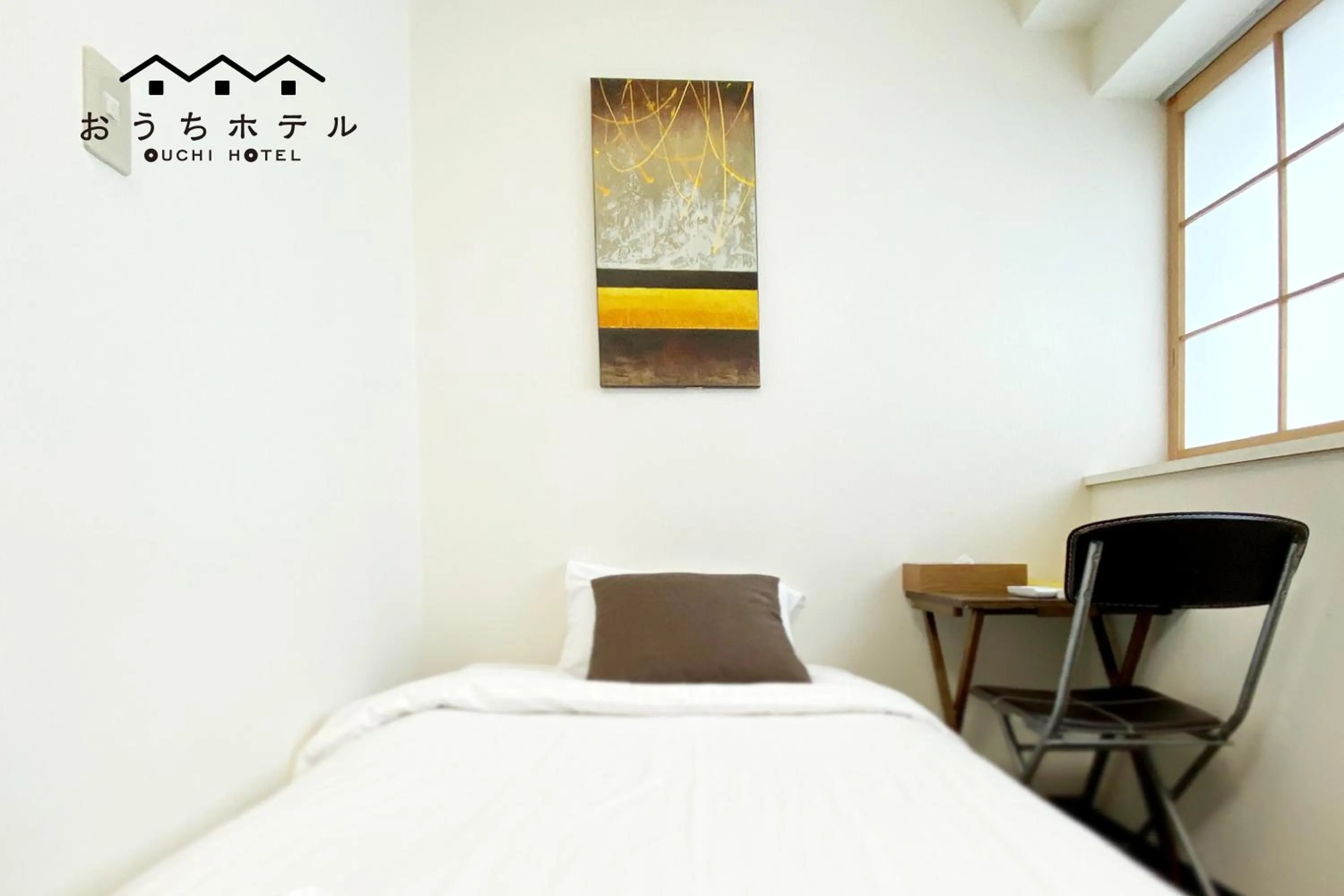 Bed in OUCHI HOTEL Yokogawa